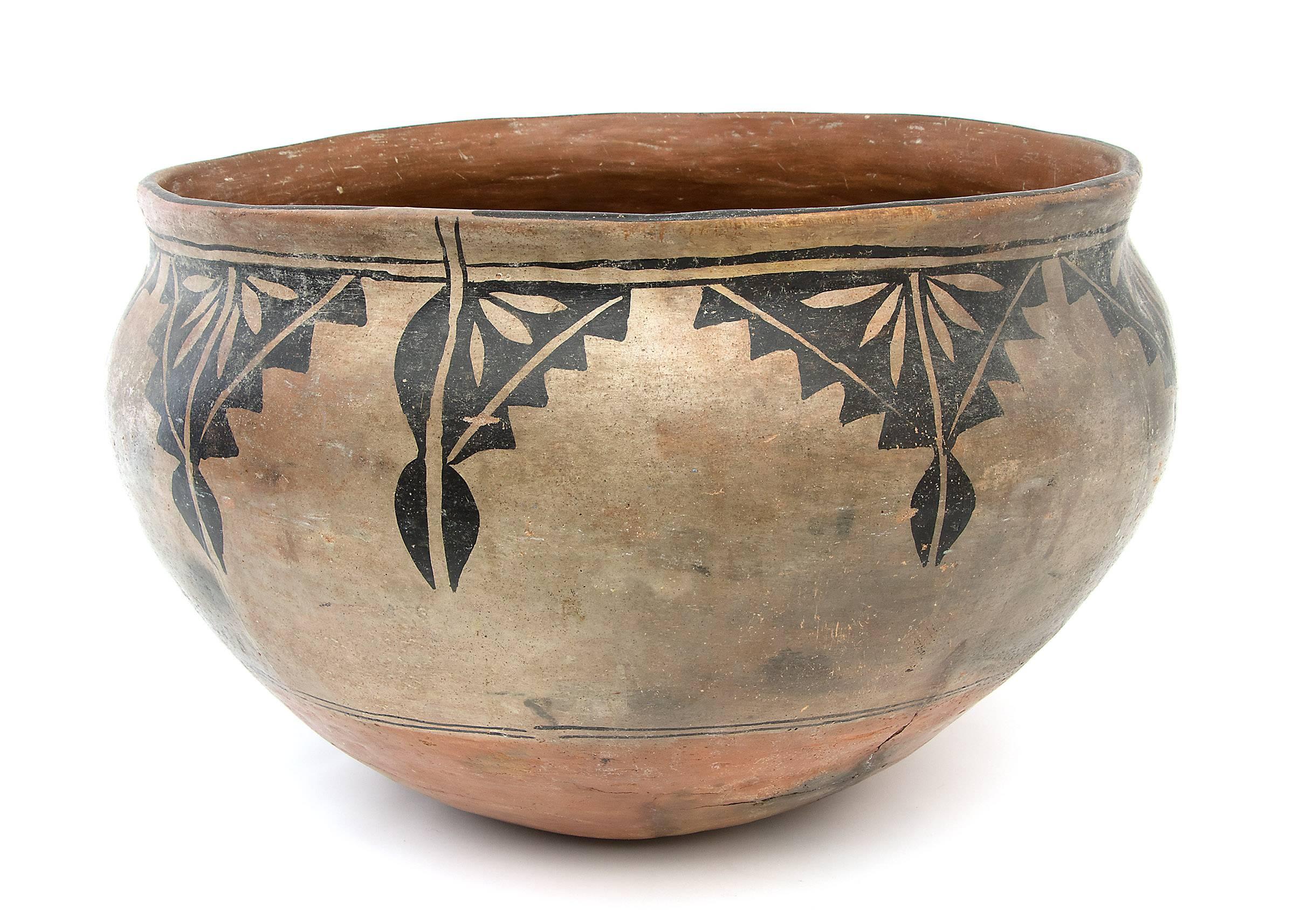 A large authentic vintage Native American southwestern antique pottery bowl from Cochiti Pueblo, early 20th century (circa 1920).  Polychrome (three color) dough bowl form constructed by hand of earthenware and painted in a traditional Cochiti