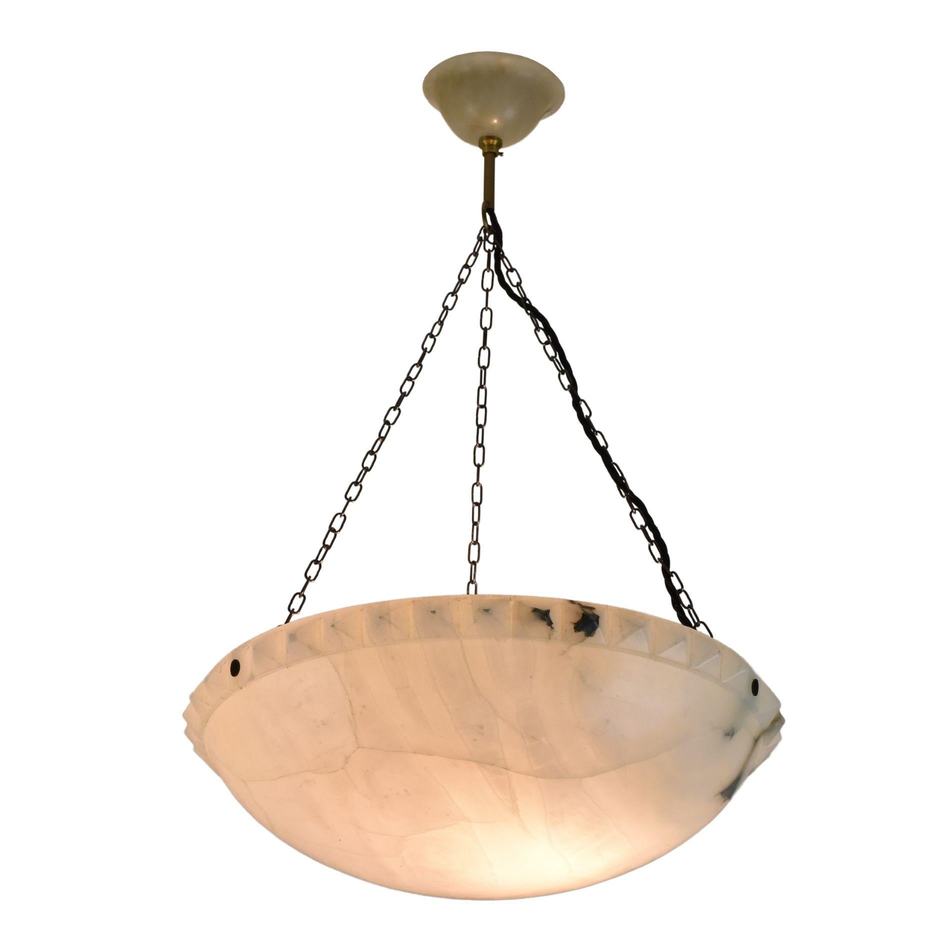 A large elegant French Art Deco alabaster ceiling lamp featuring a carved hobnail-decorated rim with its original alabaster canopy.

This lamp is fitted with an E27 socket and has been newly rewired for the European market.

The original