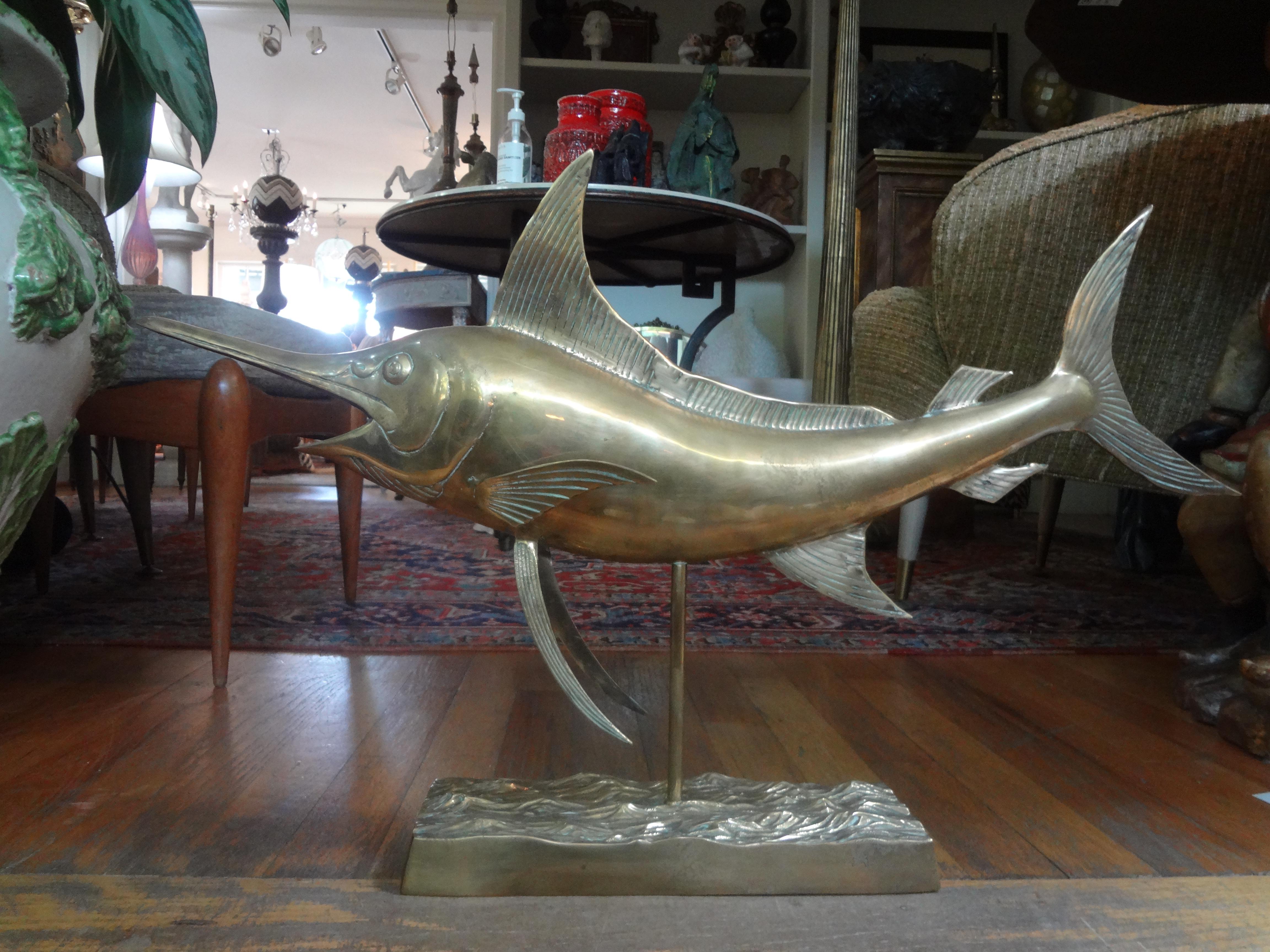 Handsome large Hollywood Regency polished brass marlin sculpture. 
Our large scale mid-century marlin sculpture is made of heavy cast brass and has a nice overall aged patina.