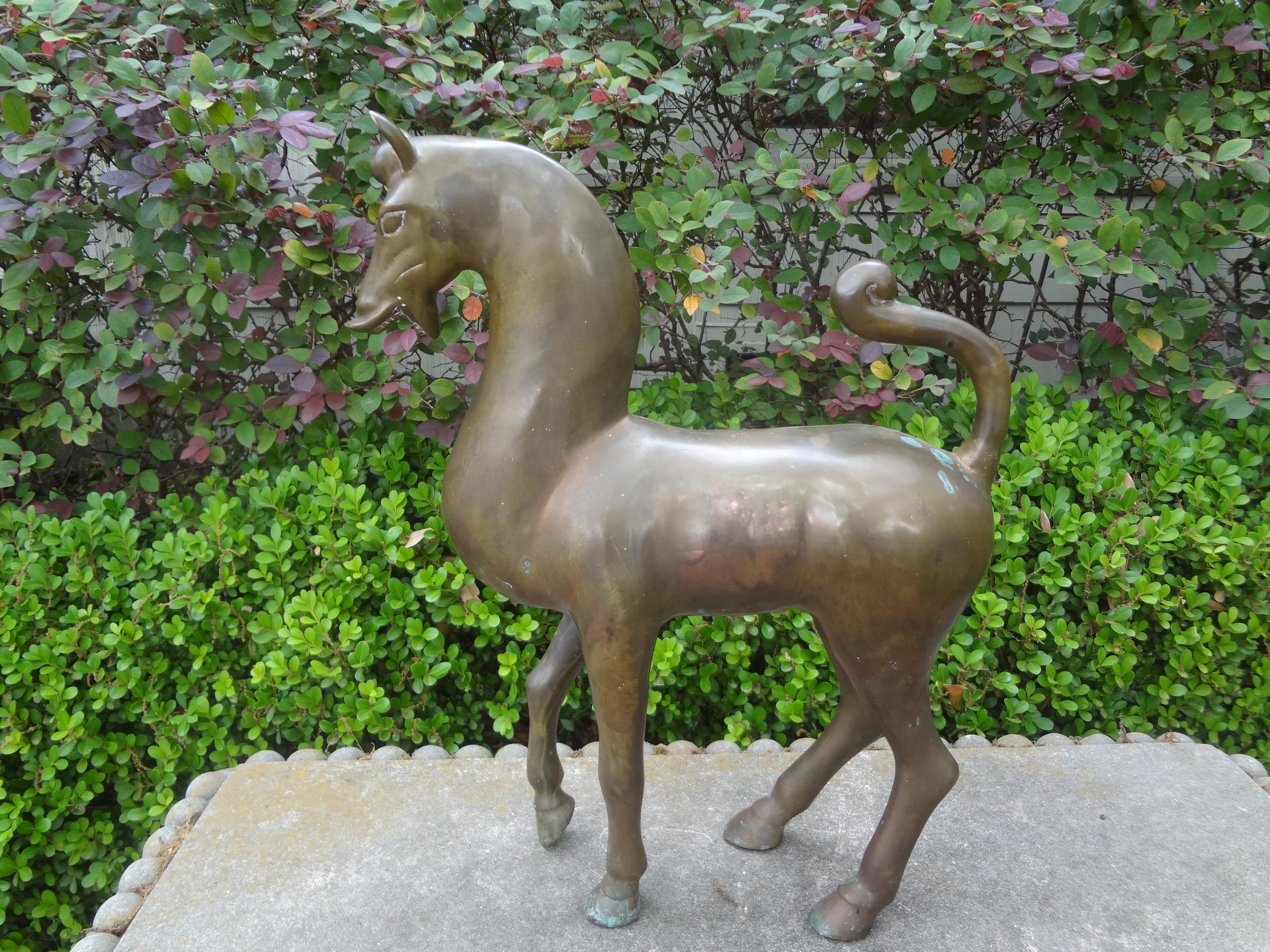 Large Hollywood Regency brass tang horse sculpture.
Stunning large vintage brass Tang horse sculpture. Our Mid-Century Modern brass horse figure or sculpture stands in a commanding position. 
Nice patina but could be highly polished if