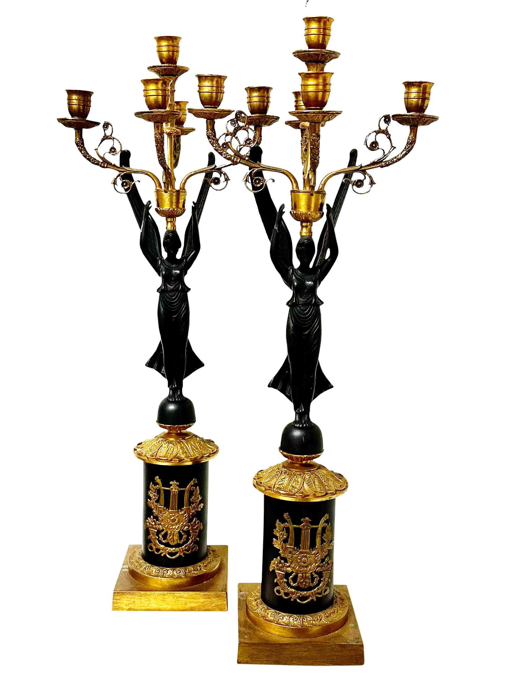 A fabulous pair of circa 1940s Italian candlesticks with five candleholders. Hollywood Regency in the empire style, dore bronze with black patina. 