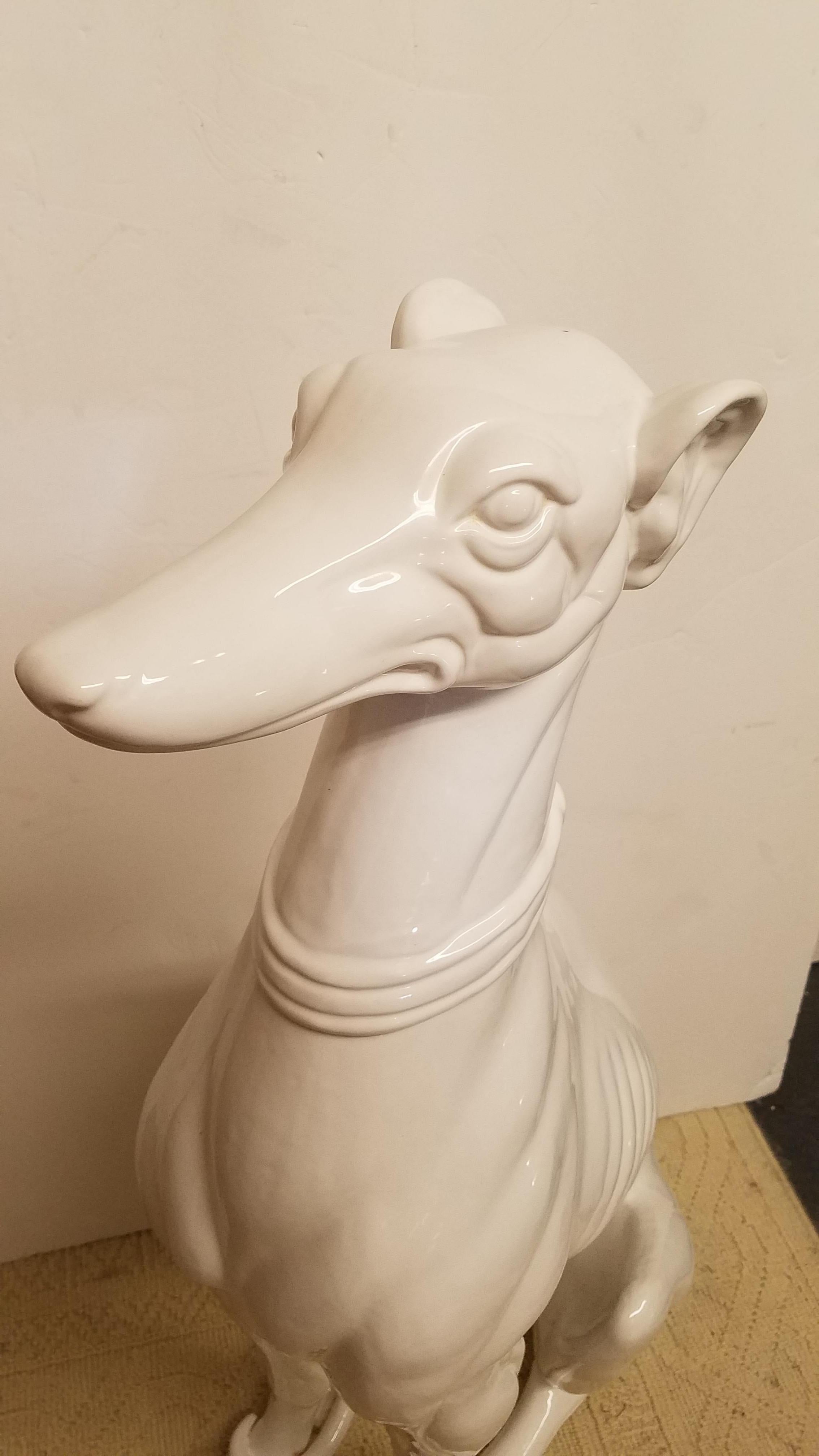 Chic Mid-Century Modern Italian statue of a Greyhound. The shapely figure with a Blanc de Chine glaze standing 38 inches tall. Italy circa 1960s.