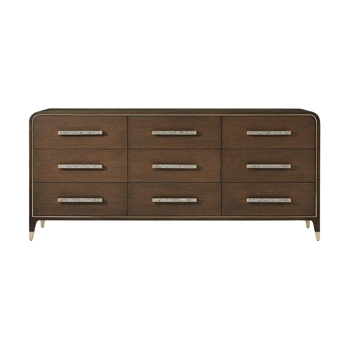 Meticulously artisan made, it serves as a luxurious statement piece for those who embrace an elegant approach to life. Shown in a rich brown Mink finish, the dresser features gracefully rounded edges framed with subtle brass inlay, exuding tailored