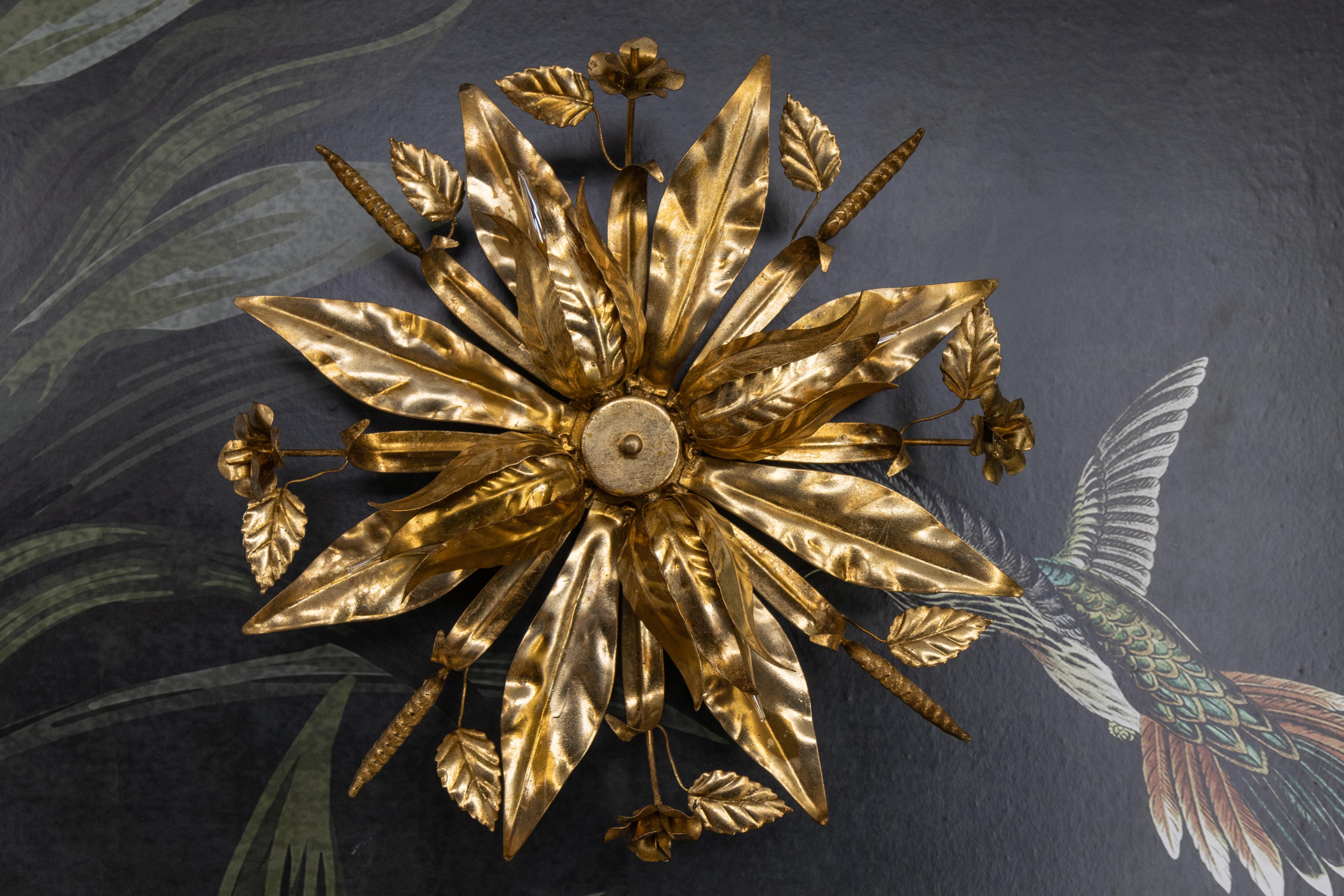 Large Hollywood Regency Gilt Metal Floral Four-Light Flush Mount or Wall Sconce, Attributed to Hans Kögl, 1970s.

This striking and sculptural gilt metal light fixture, attributed to Hans Kögl and dating to the 1970s, exemplifies the opulent