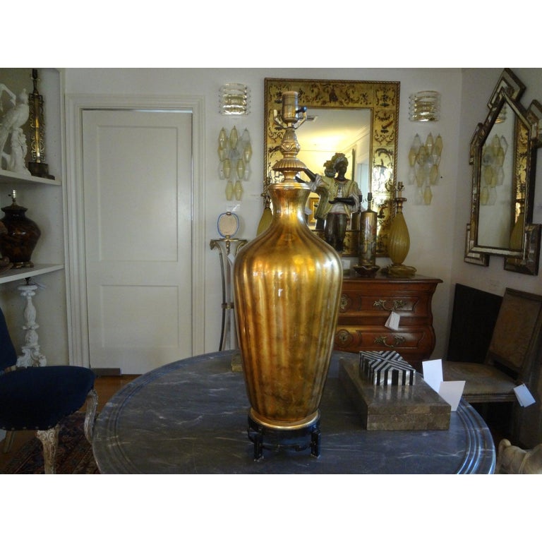 Large scale Italian gold blown glass on interesting Asian Modern iron base. This high quality Hollywood Regency lamp is attributed to Marbro and would look great in a variety of interiors.
    
