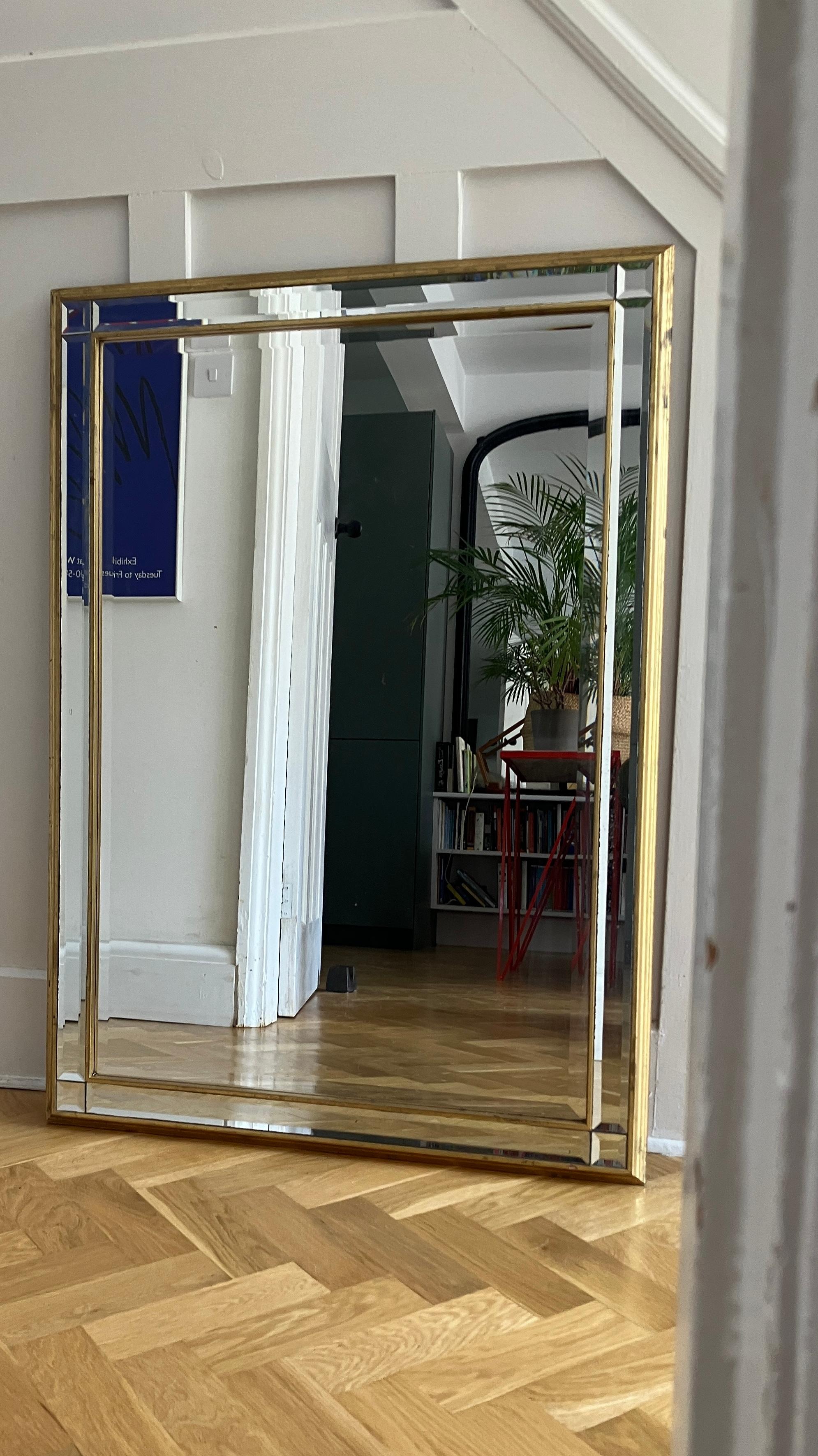 An attractive large Hollywood Regency-style mirror with a gold frame. The mirror has multiple bevel mirror sections, making it glow with light from different directions. This vintage mirror can be used either horizontally or lengthways; so ideal