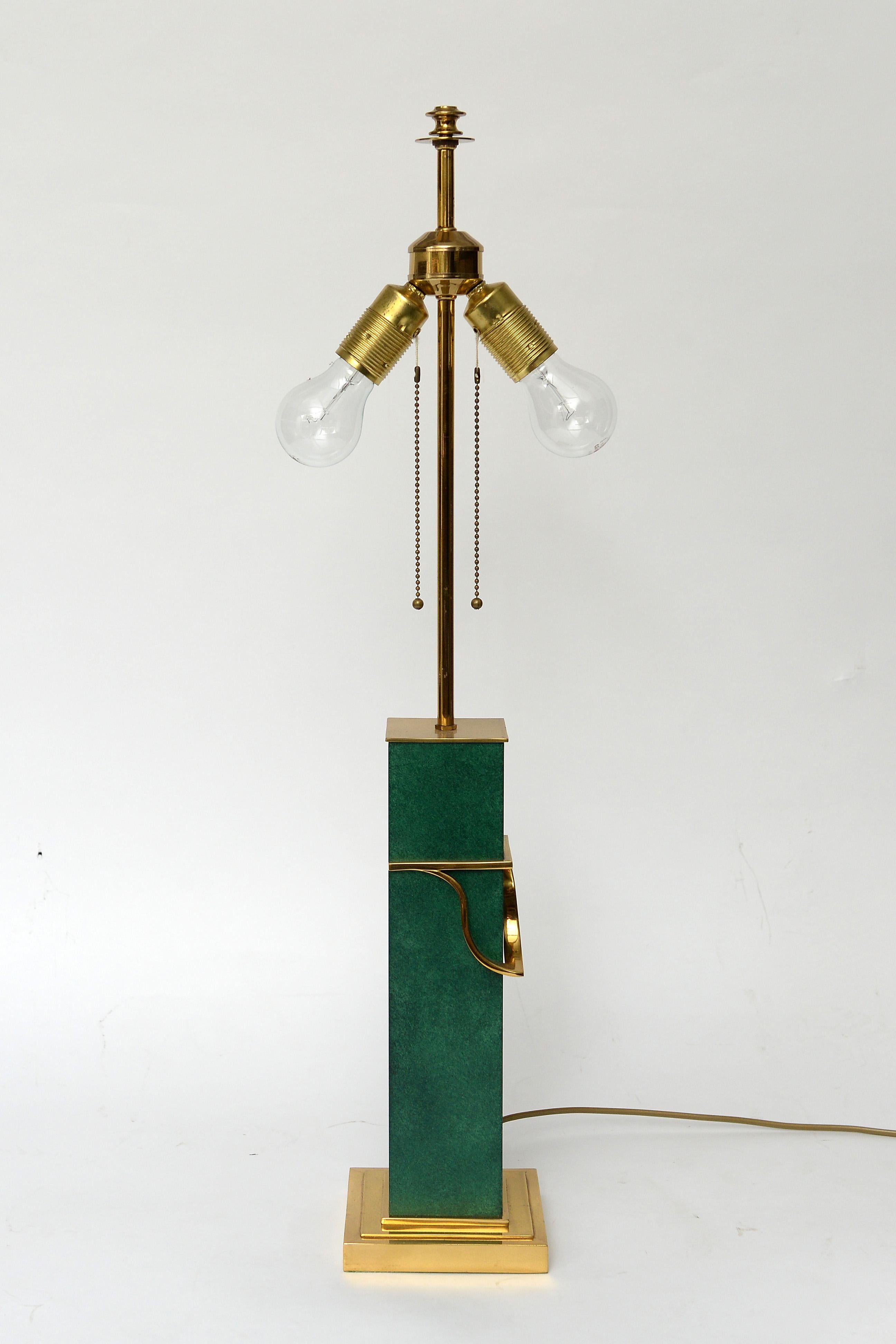 Stately and heavy green table lamp.

This decorative table lamp is mostly made from brass with a green central piece.

It comes with an impressive shade and has two- light points which can be illuminated separately with a brass pulling cord.