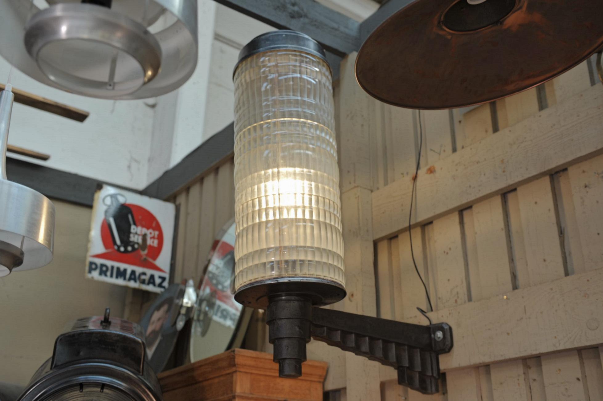 Very large and rare and great quality Holophane hotel wall lantern light in cast iron base with typical 1925 Art Deco decor, thick prismatic glass and metal cap to unscrew and change bulbs. Lampe rewired for screw bulbs all in excellent condition,