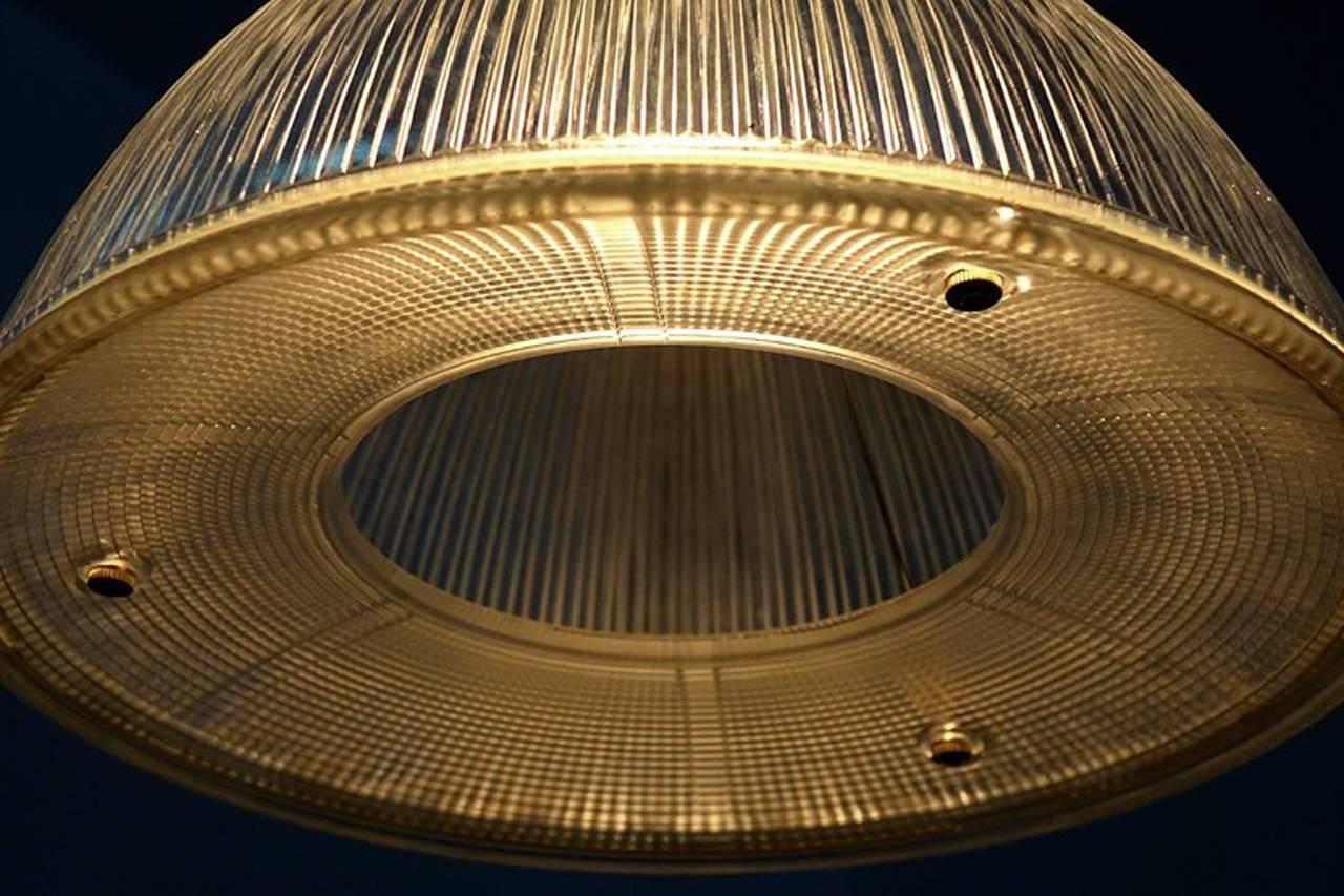 We have a number of these large Holophane lamps in stock. They are priced per lamp. All have a unique concave doughnut shaped bottom skirt. It finishes off the dome nicely and gives it a very different look. It also has a Mid-Century Modern feel to
