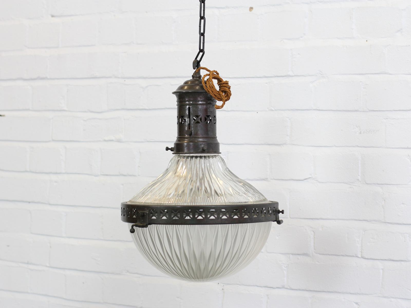 Large holophane pendant light, circa 1910

- Detailed copper gallery and rim
- Comes with 100cm of gold braided cable
- Comes with ceiling rose and black chain
- Takes E27 fitting bulbs
- Prismatic glass
- French, circa 1910
- 34cm wide x