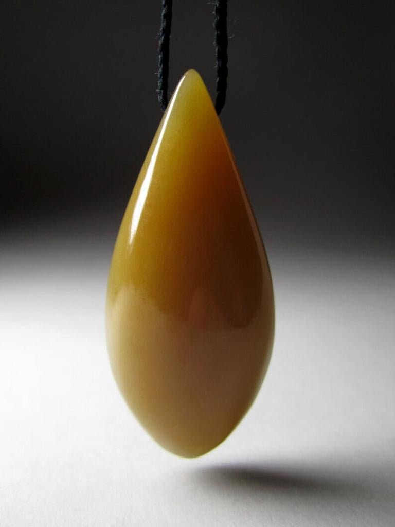 A vintage jewelry piece from a private collection of a geologist:
Natural honey Jade pendant on a cord
stone measurements - 0.39 x 0.83 x 1.97 in / 10 х 21 х 50 mm
pendant weight - 20.03 grams