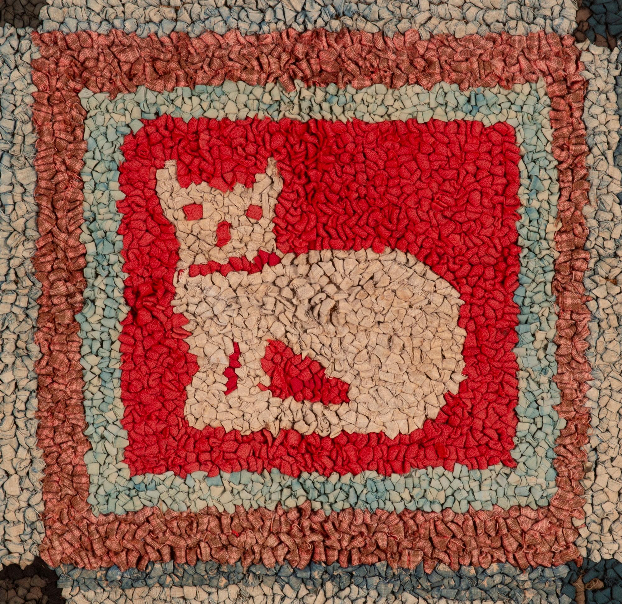 	LARGE HOOKED RUG WITH A SEATED CAT AS THE HOME SQUARE OF A DESIGN STYLED AFTER A PARCHEESI GAME BOARD, WITH STAR-LIKE, 6-PETAL FLOWERS IN EACH CORNER; WOOL & COTTON ON BURLAP, PROBABLY PENNSYLVANIA, MENNONITE, circa 1880-1910

Early, hooked,