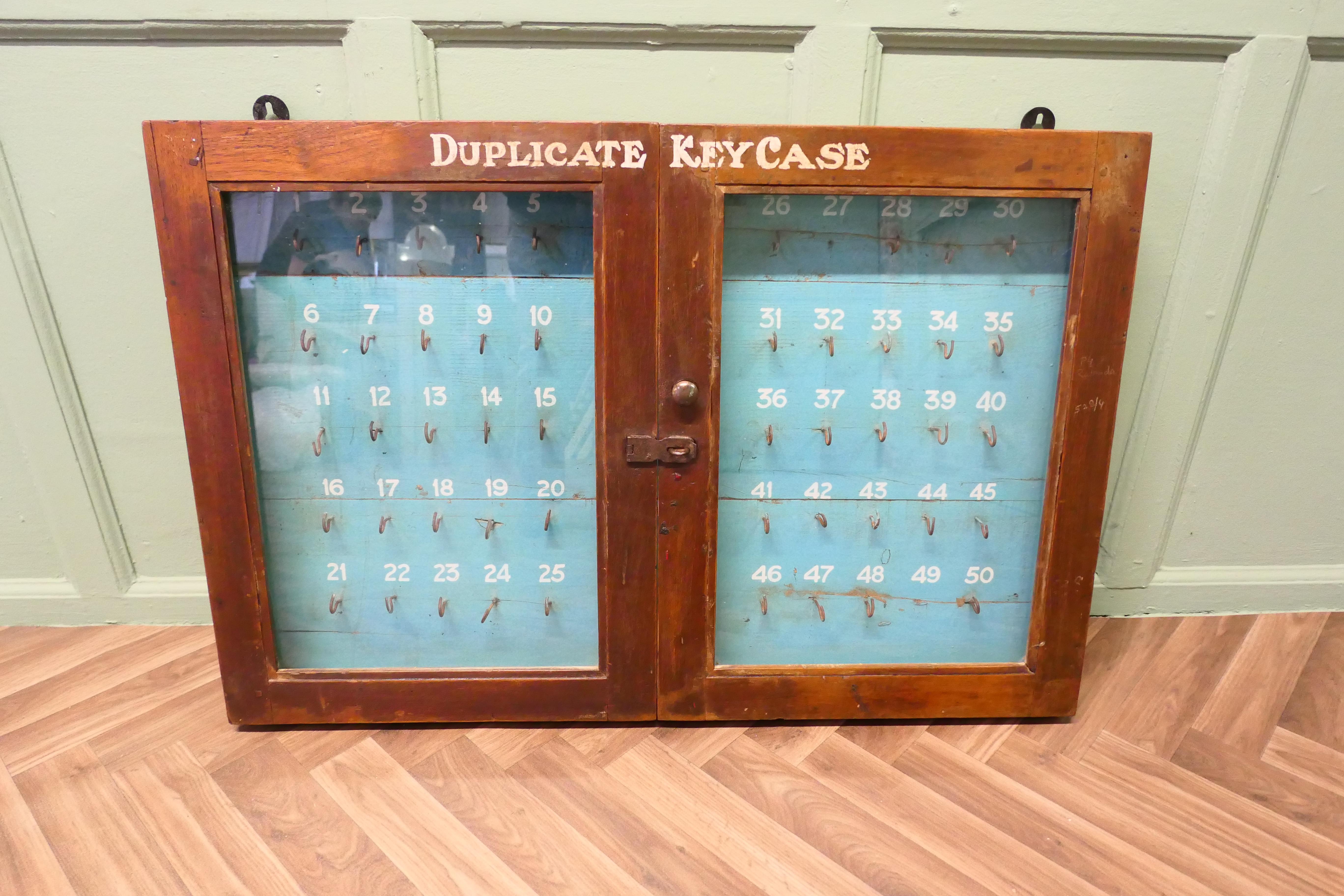 Large Hotel 50 Bedroom Wall Hanging Key Cupboard  

This is a large 2 door glass fronted key cupboard it has 50 numbered hooks, some of the hooks are missing but we can add them if needed
The cabinet is strong and can have an external lock added as