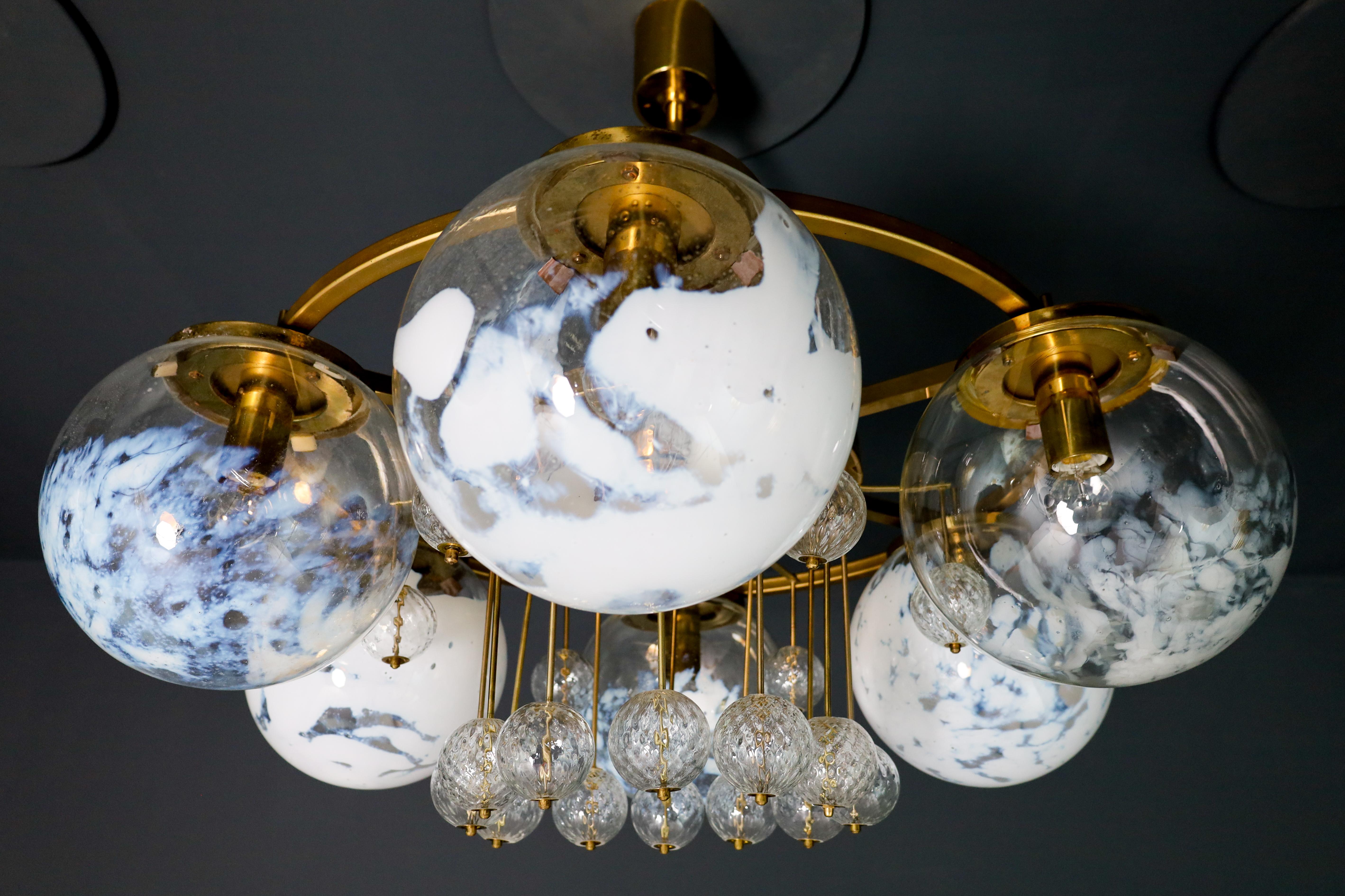Large Hotel Chandelier in Brass and Hand Blown Glass 1950s

A grand Chandelier with brass fixture produced and designed in Czechia Bohemian in the 1960s. There are six large mouthblown,  Art-glass globes and 18 smaller structured globes. The