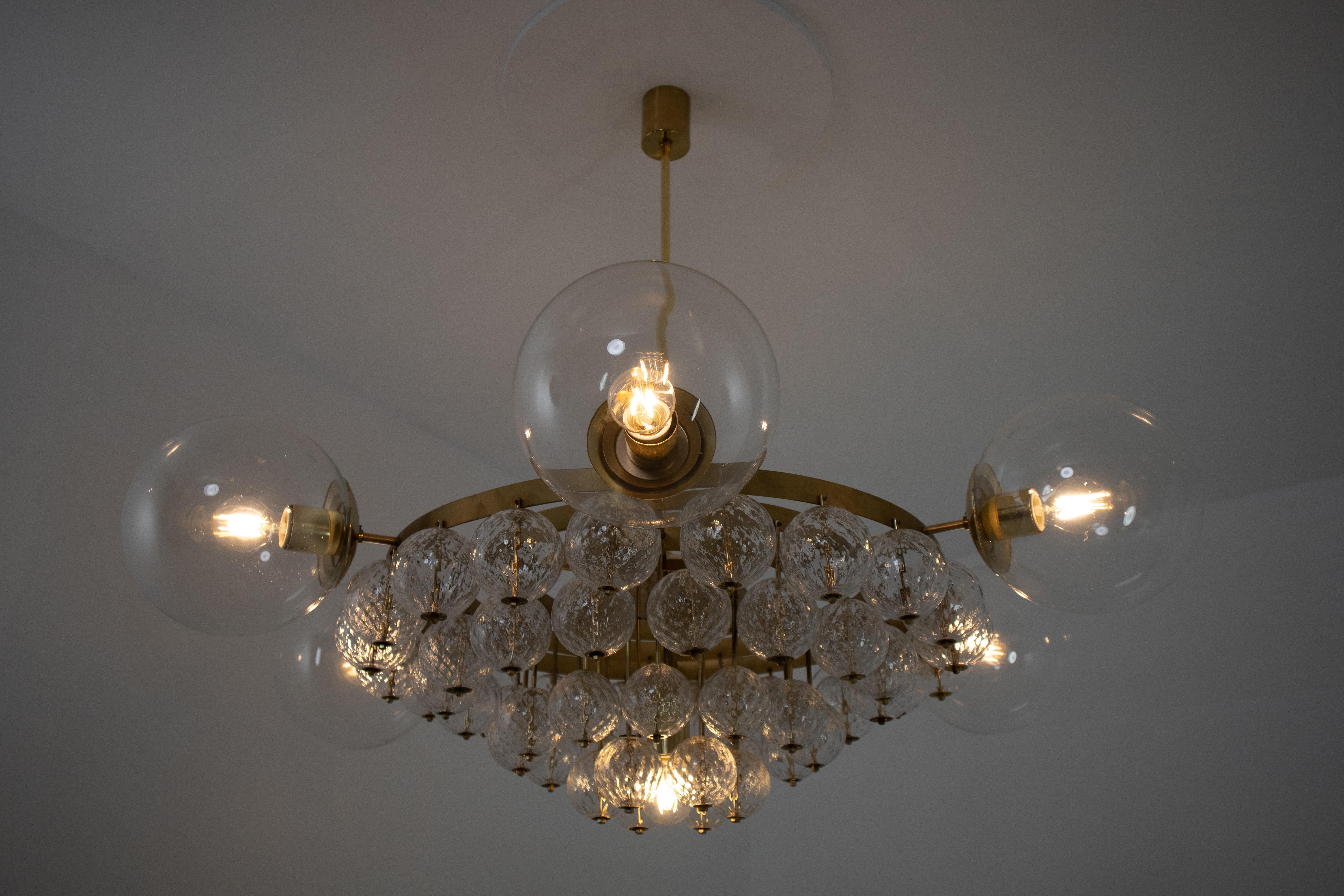 Mid-Century Modern Large Hotel Chandeliers with Brass Fixture and Structured Glass Globes For Sale
