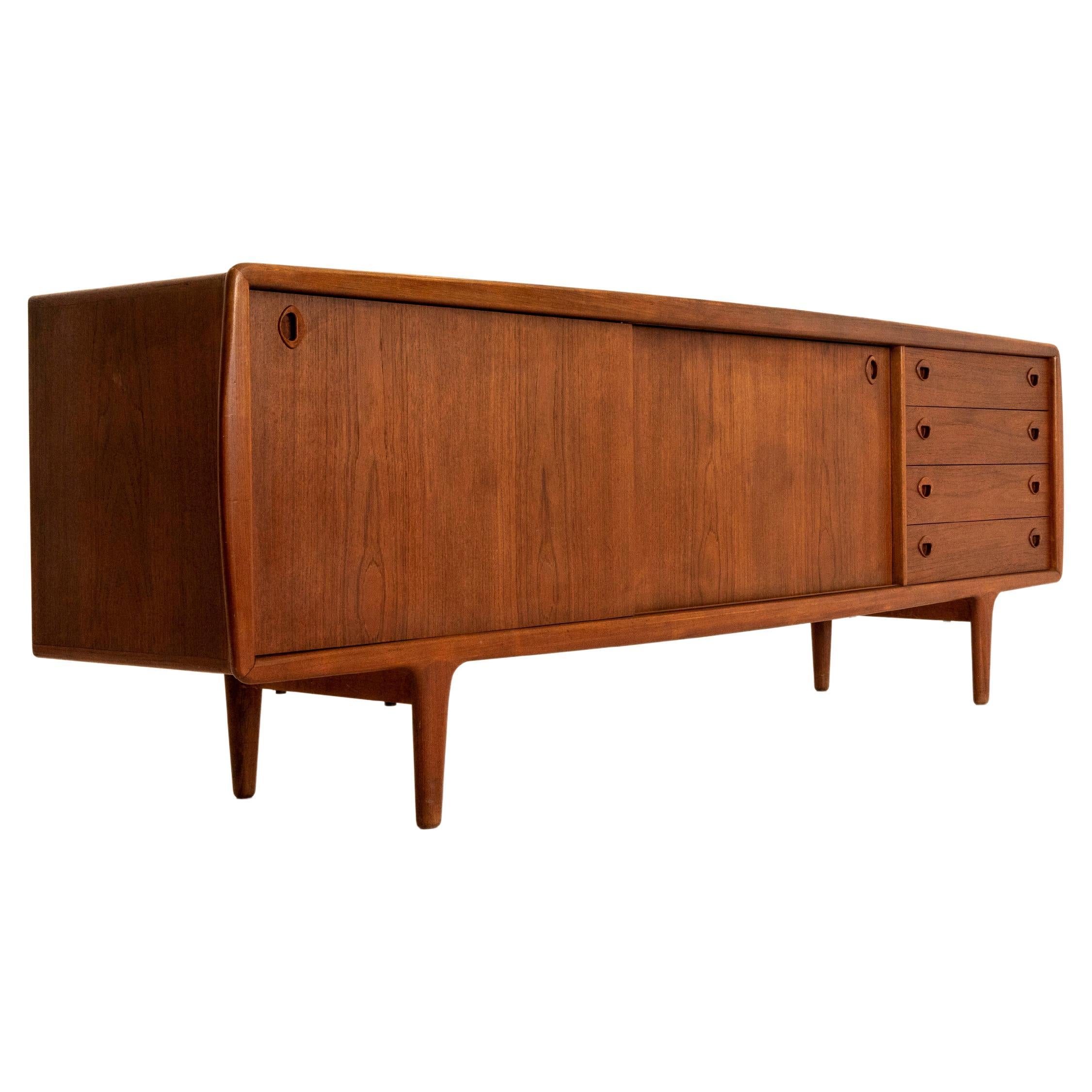 Large H.P. Hansen Sideboard in teak veneer for IMHA from Denmark 1960s. This sideboard has an impressive size and is very functional. It has two sliding doors and four drawers. It has the Danish vintage signature design by H.P. Hansen with round