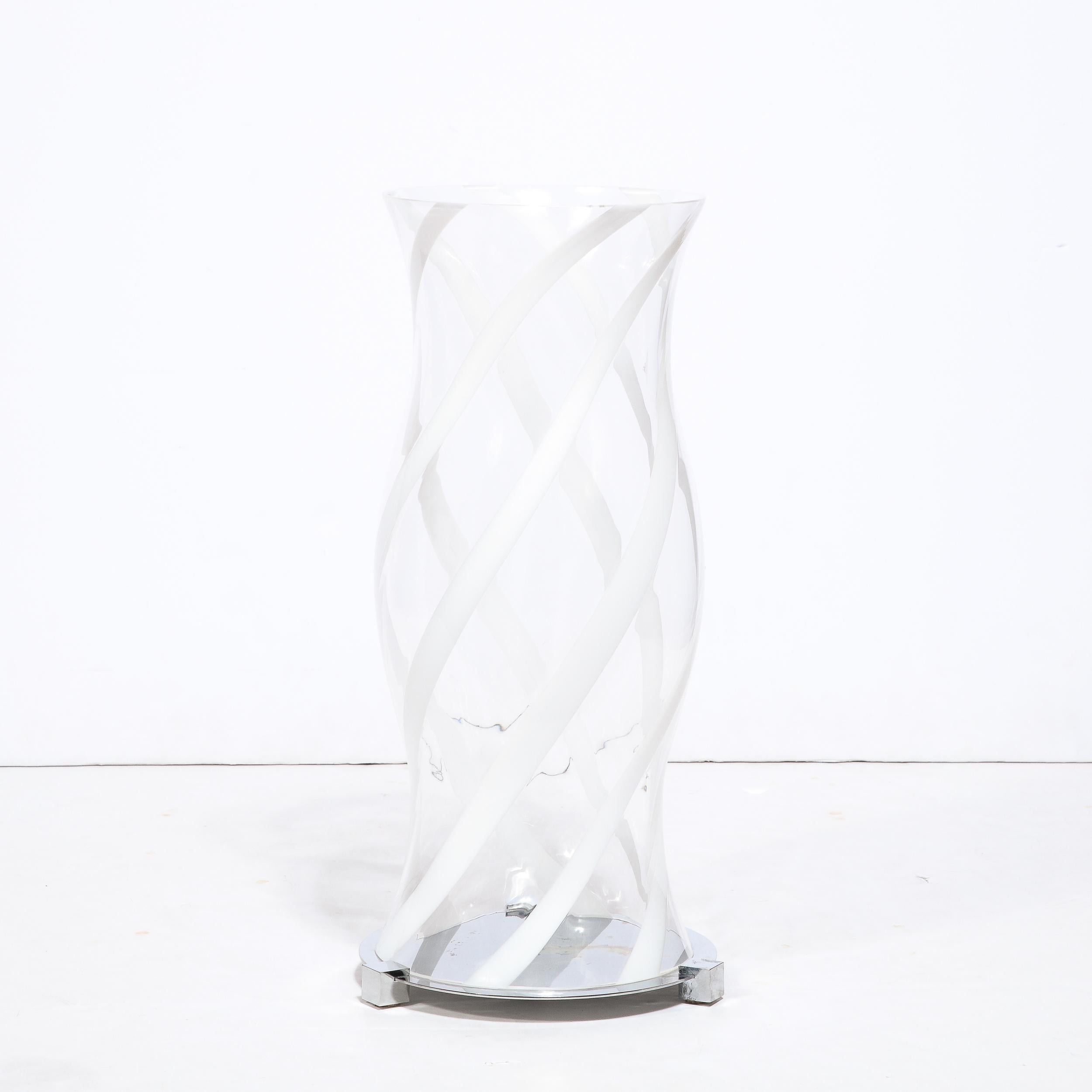 This stunning pair of large scale hurricane candle holders were realized in Murano, Italy- the island off the coast of Venice renowned for centuries for its superlative glass production- during the latter half of the 20th century. They feature