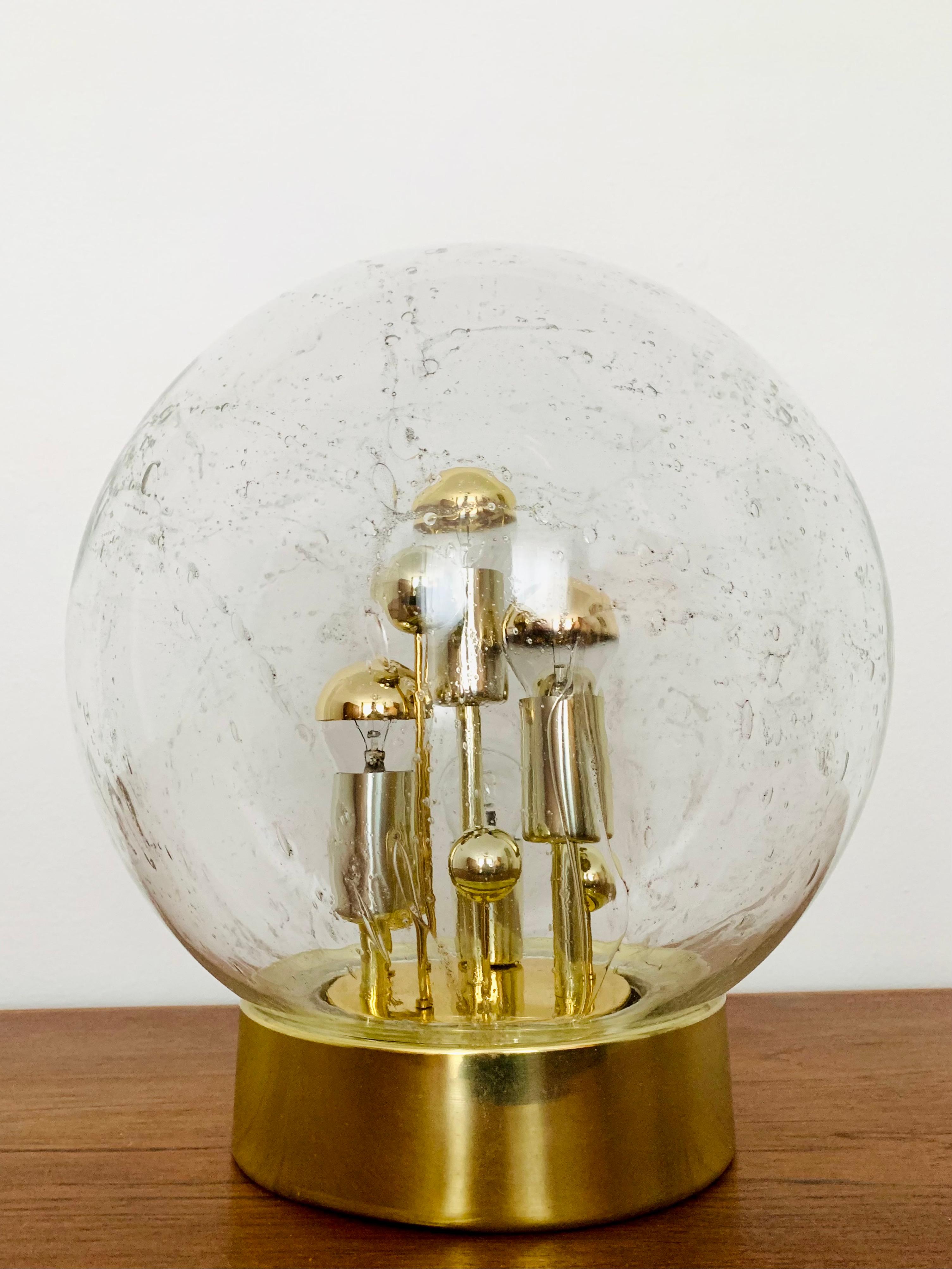 Very beautiful and large golden Big Ball table lamp by Doria from the 1960s.
Very elegant Hollywood Regency design with a fantastically glamorous look.
The structure in the glass creates a spectacular sparkling light.

Manufacturer: