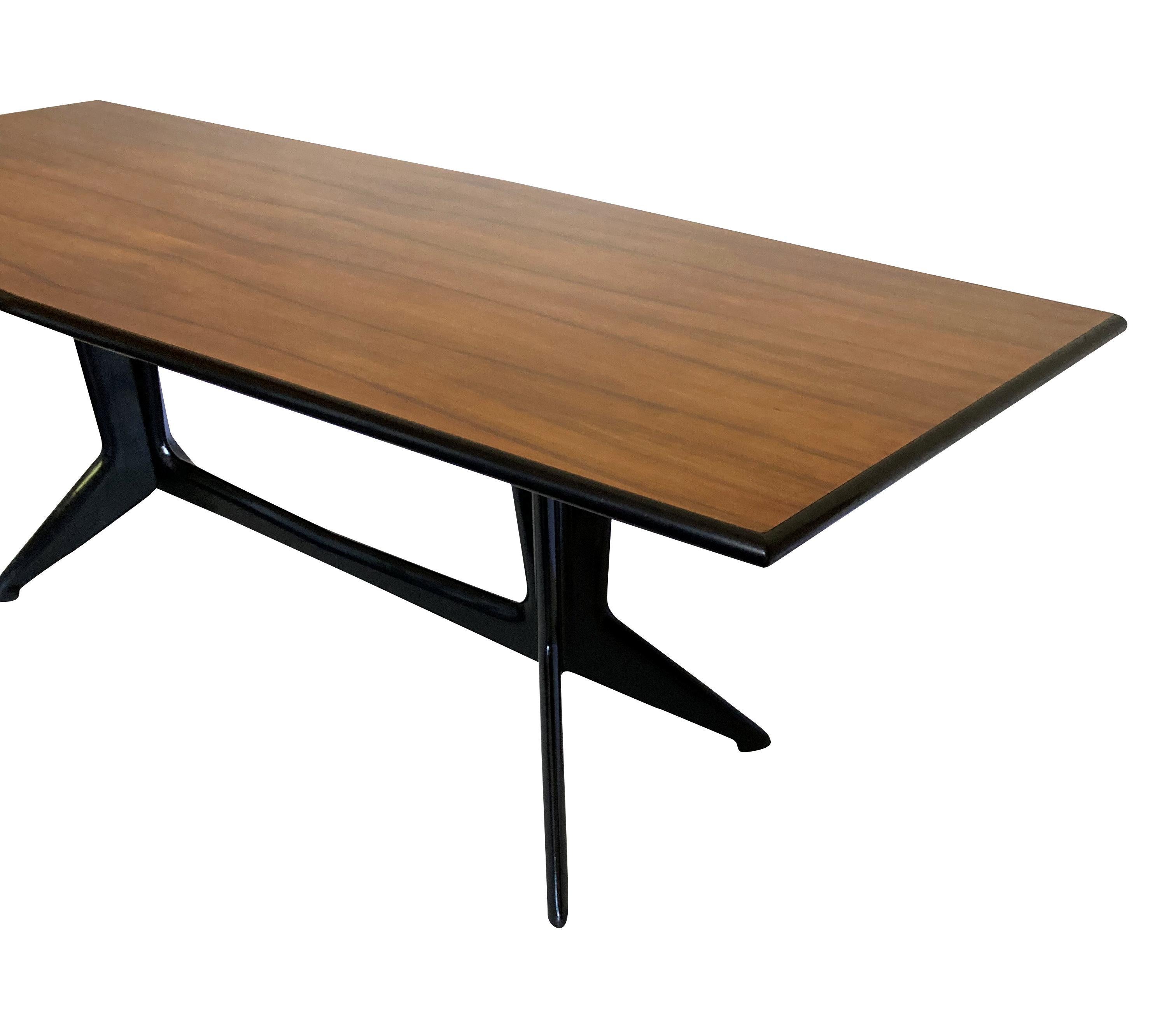 A large Italian Mid-Century dining table by Ico Parisi, with ebonised architectural legs and a pau ferro veneered top, with ebonised edge. This table will comfortably seat twelve.