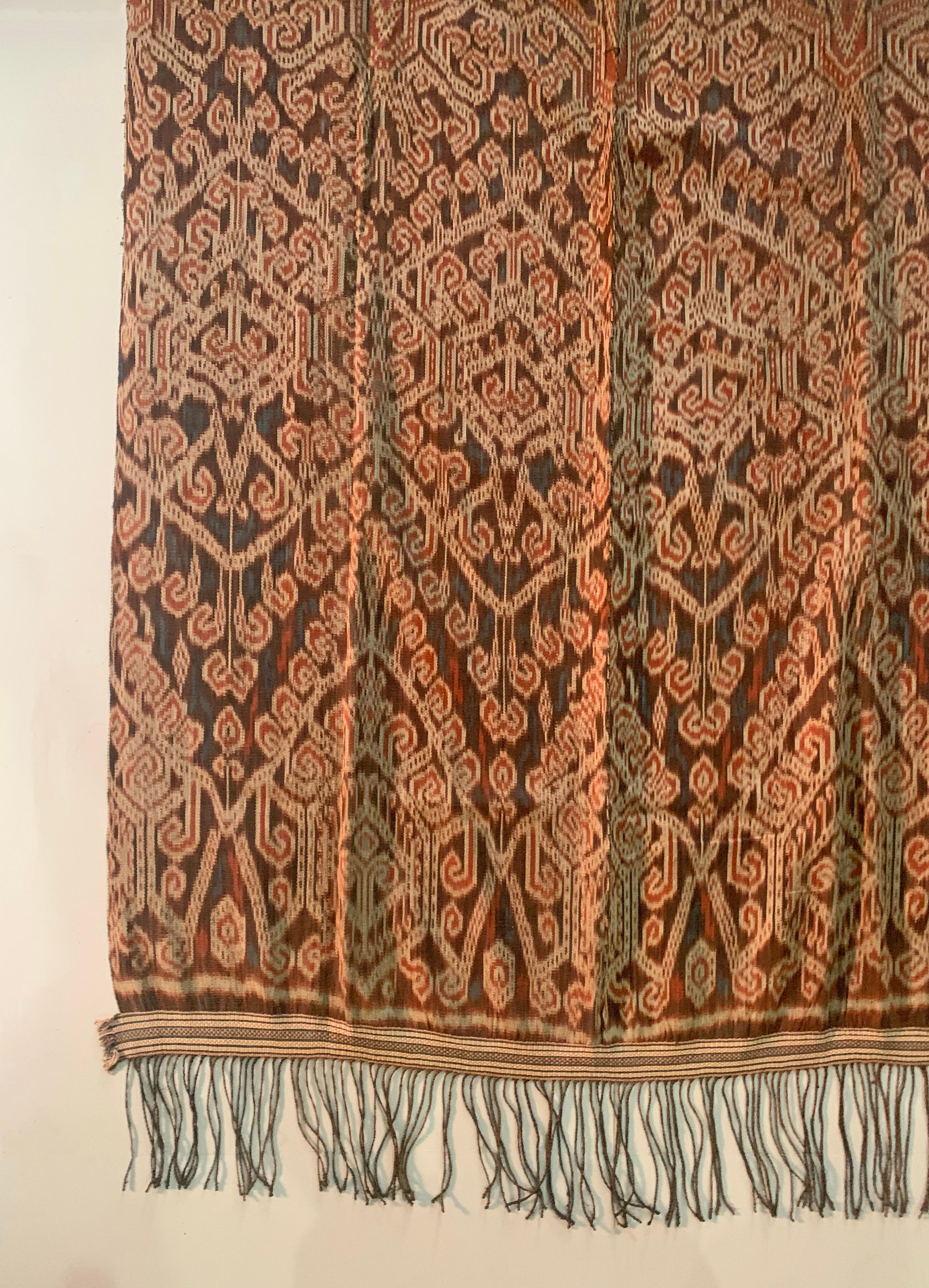 This Ikat textile originates from the Island of Sumba, Indonesia. It is hand-woven using naturally dyed yarns via a method passed on through generations. It features a stunning array of distinct tribal patterns. It takes months to complete a single