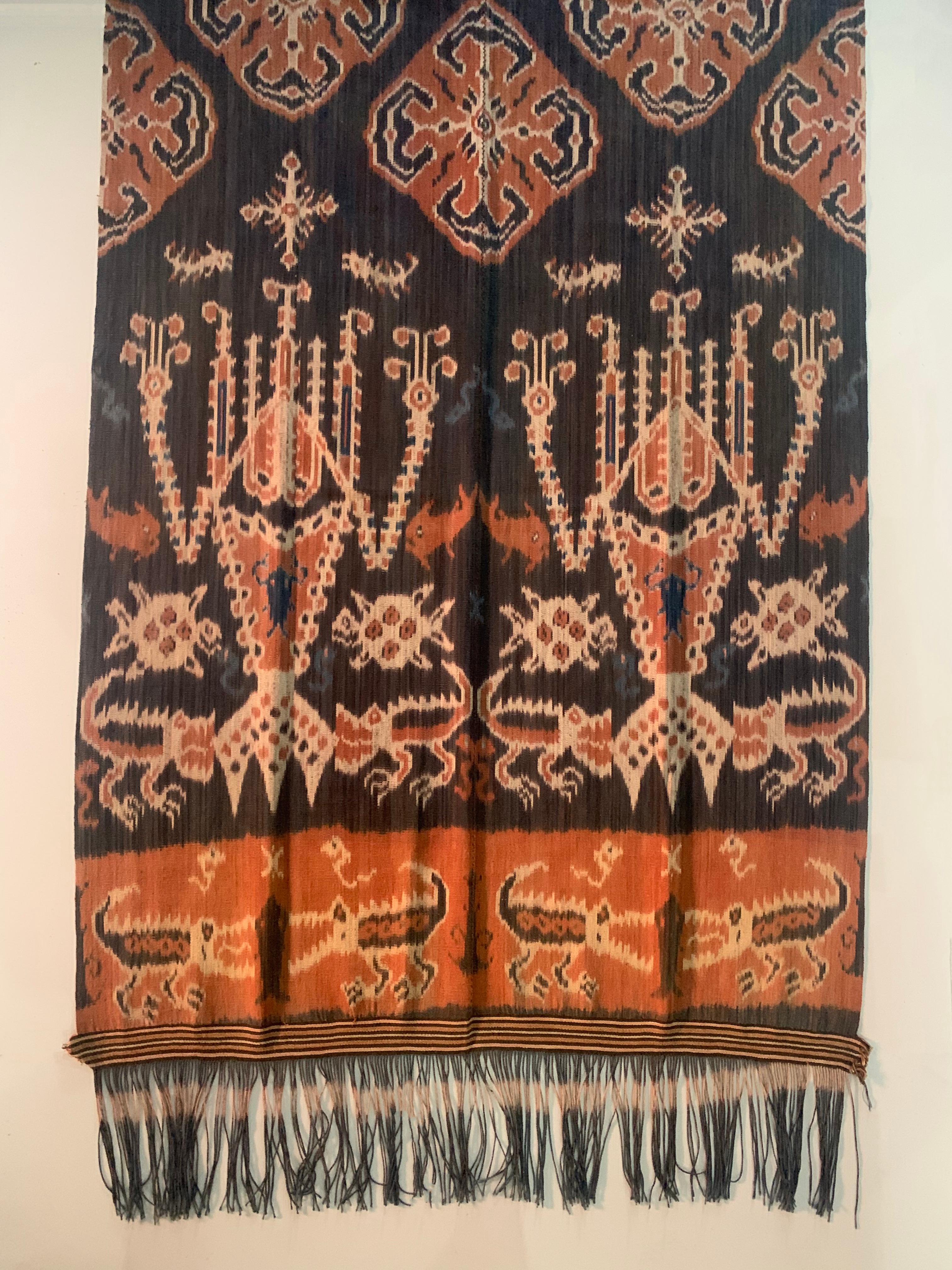 This Ikat textile originates from the Island of Sumba, Indonesia. It is hand-woven using naturally dyed yarns via a method passed on through generations. It features a stunning array of distinct tribal patterns as well as crocodile, fish & turtle