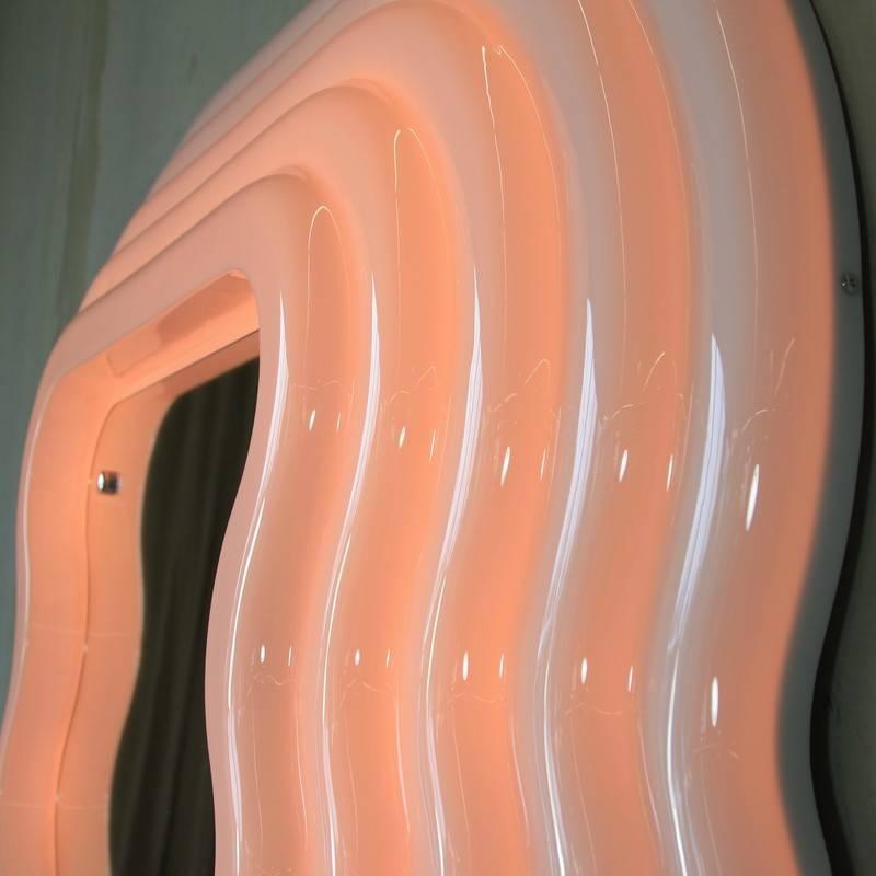 Ultrafragola mirror, designed by Ettore Sottsass, Italy, 1970.

Recent production mirror made of moulded fibreglass with wooden back and shaped mirror. The frame is white, turning pink when neon light is switched on.

            