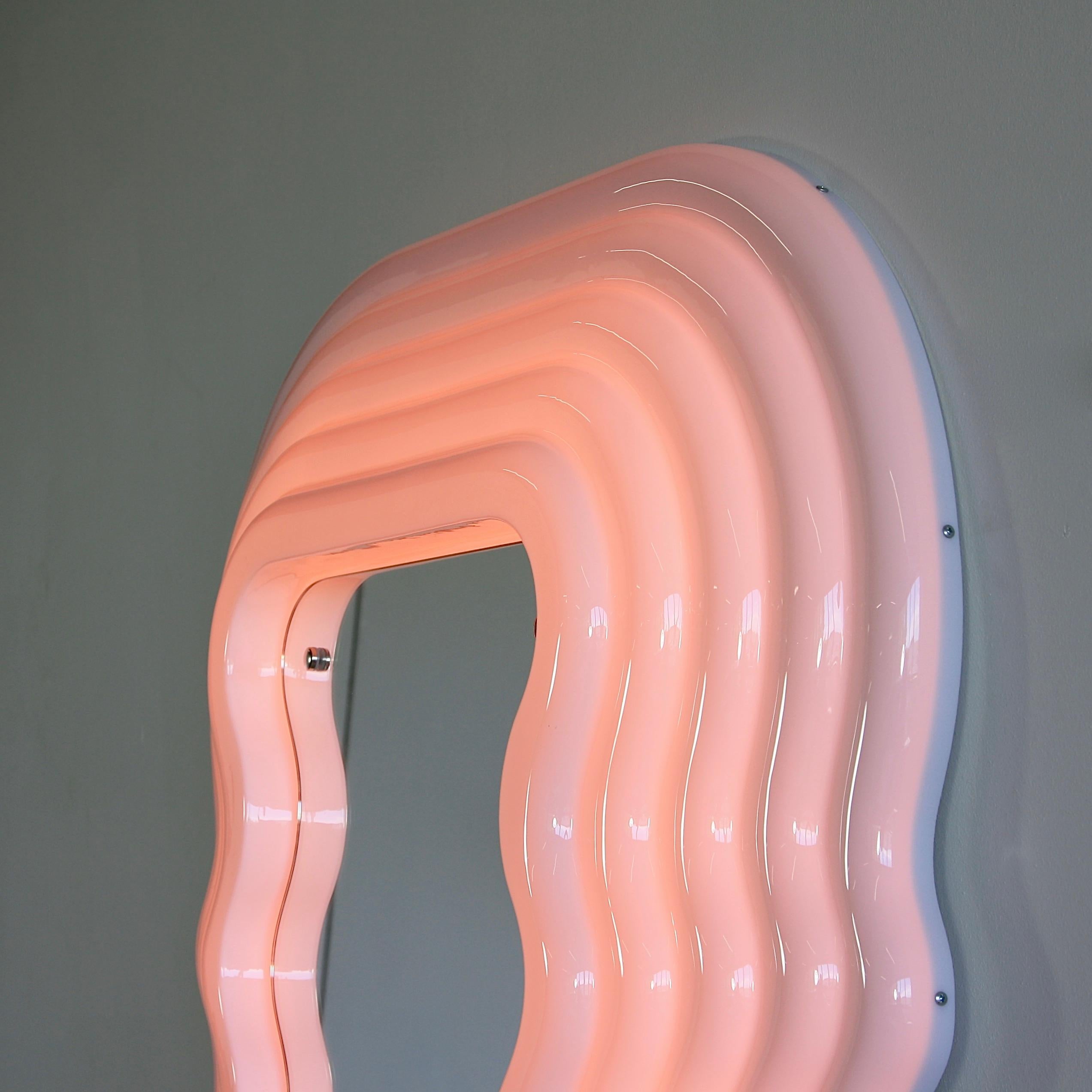 Ultrafragola mirror, designed by Ettore Sottsass, Italy, 1970.

Recent production mirror made of moulded fibreglass with wooden back and shaped mirror. The frame is white, turning pink when neon light is switched on.

 