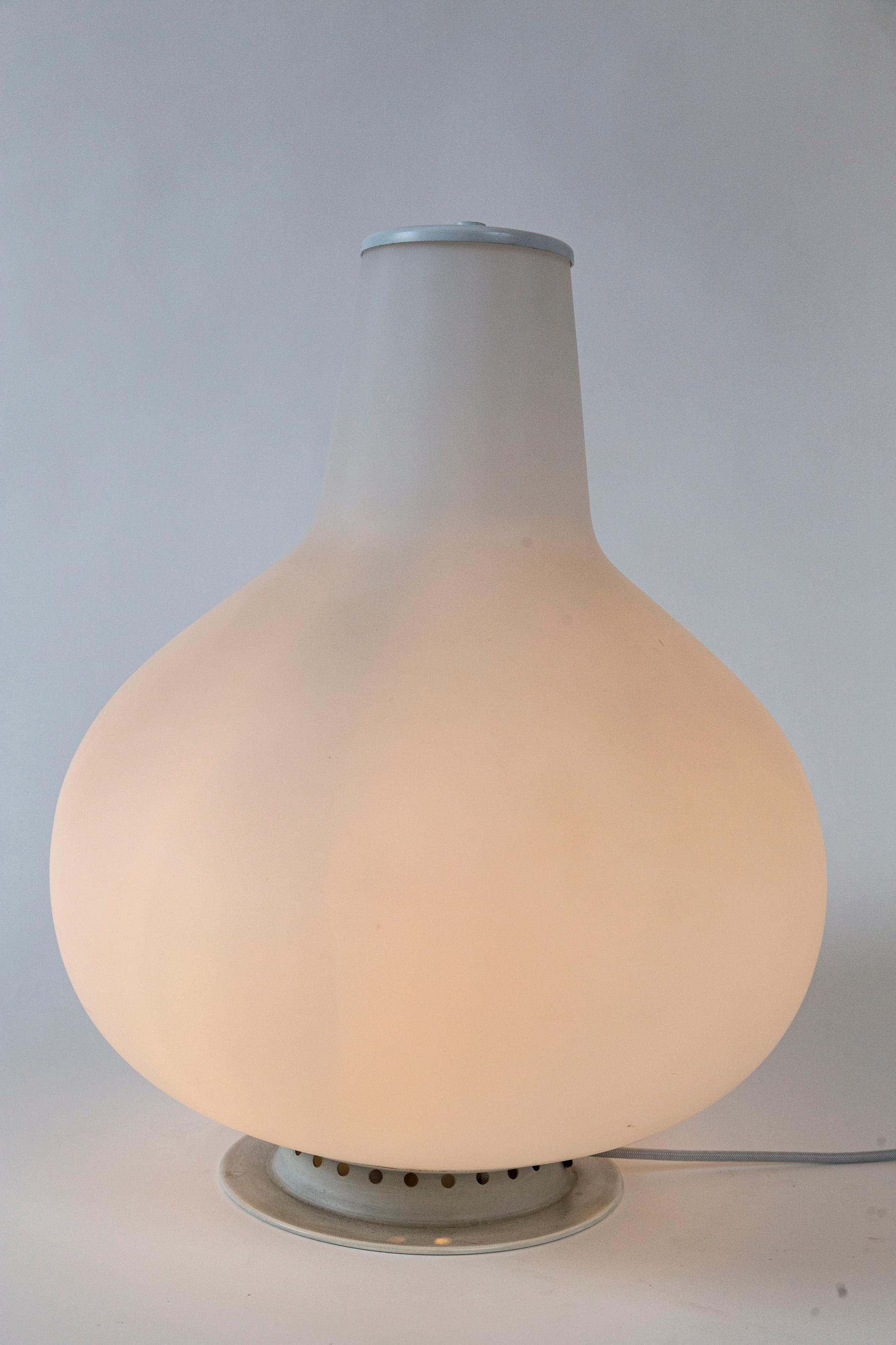 Period Single capped vase in a satin white blown glass by Max Ingrand for Fontana Arte, with illumination in the base of the vase
made in  opaline glass and metal
re-electrified to US code with new socket and light grey silk cording with