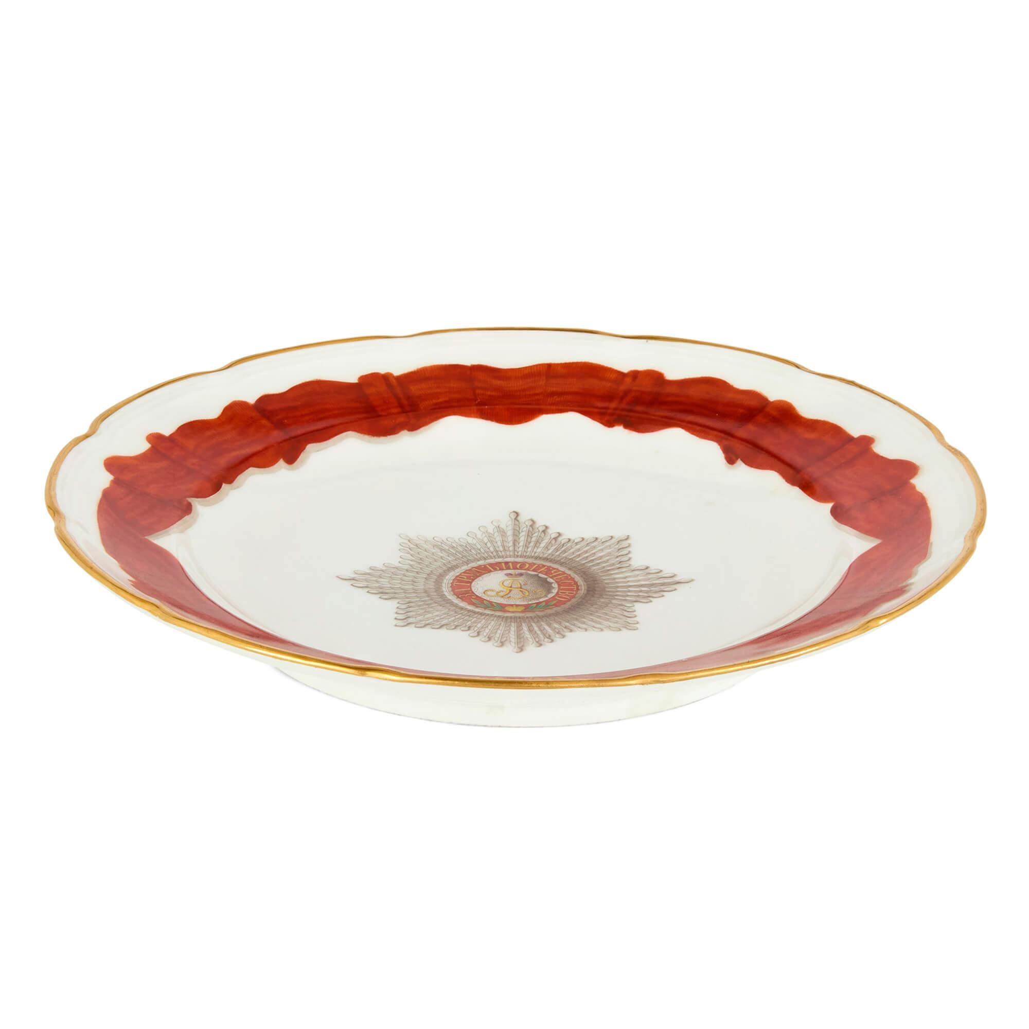 Large Imperial Porcelain Alexander II period plate
Russian, mid-19th Century 
Height 24cm, width 24cm, depth 3.5cm

This impressive 19th-century plate is an artefact of Russian Imperial history.

Of circular form with a cream ground predominating,