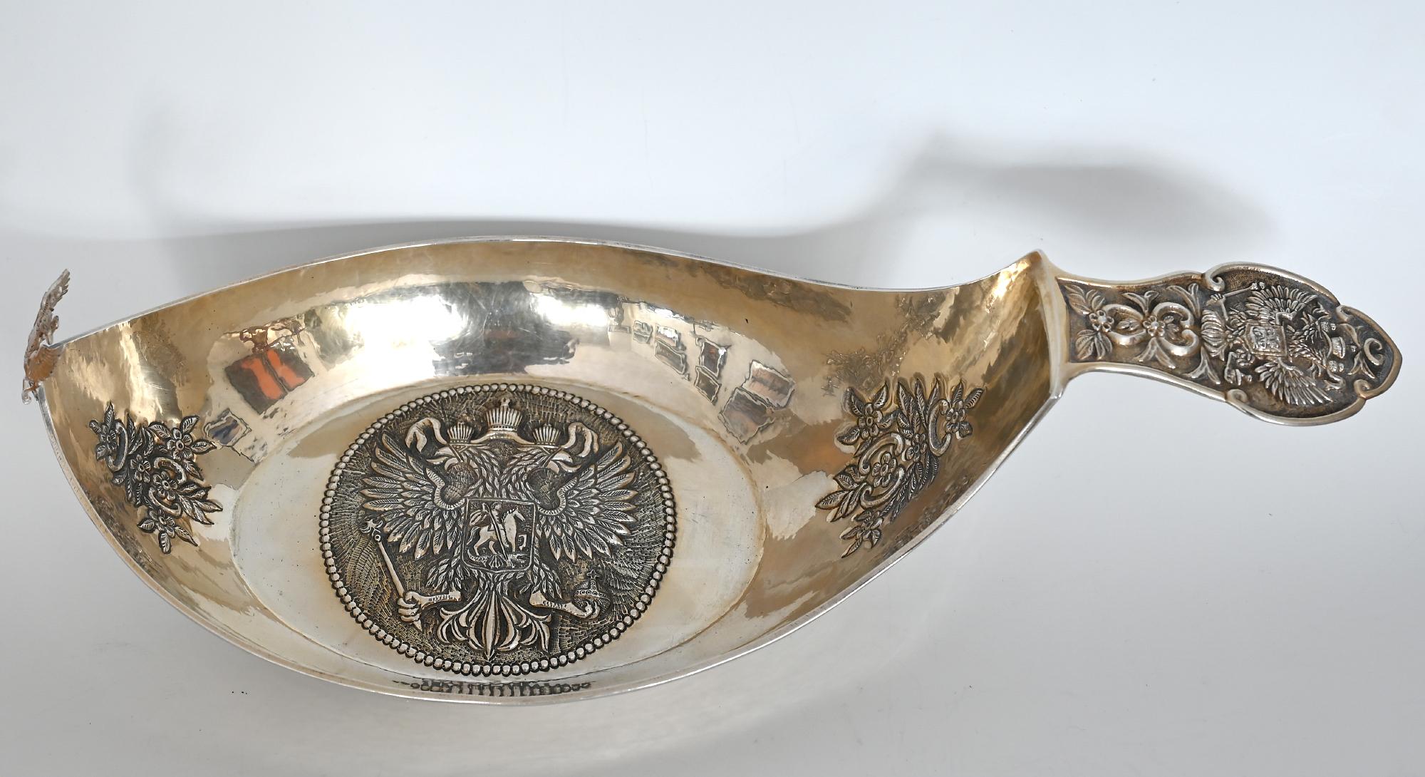 Large and important, ship shaped Imperial Kowsch , with the crowned double eagle and the rulers insignete on the base, the handle and the front.
In the middle of the ship you can see an eagle on the base and on the handle is St. George. The Kowsch