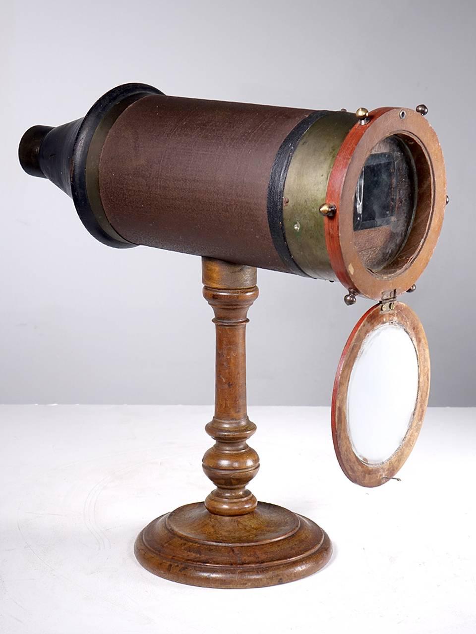 This scope is unsigned and was acquired from a European collector. It could be American but I'm guessing its not. The eyepiece and turning mechanism are brass. The tube is canvas wrapped and the tapered back is turned wood. The unique feature on