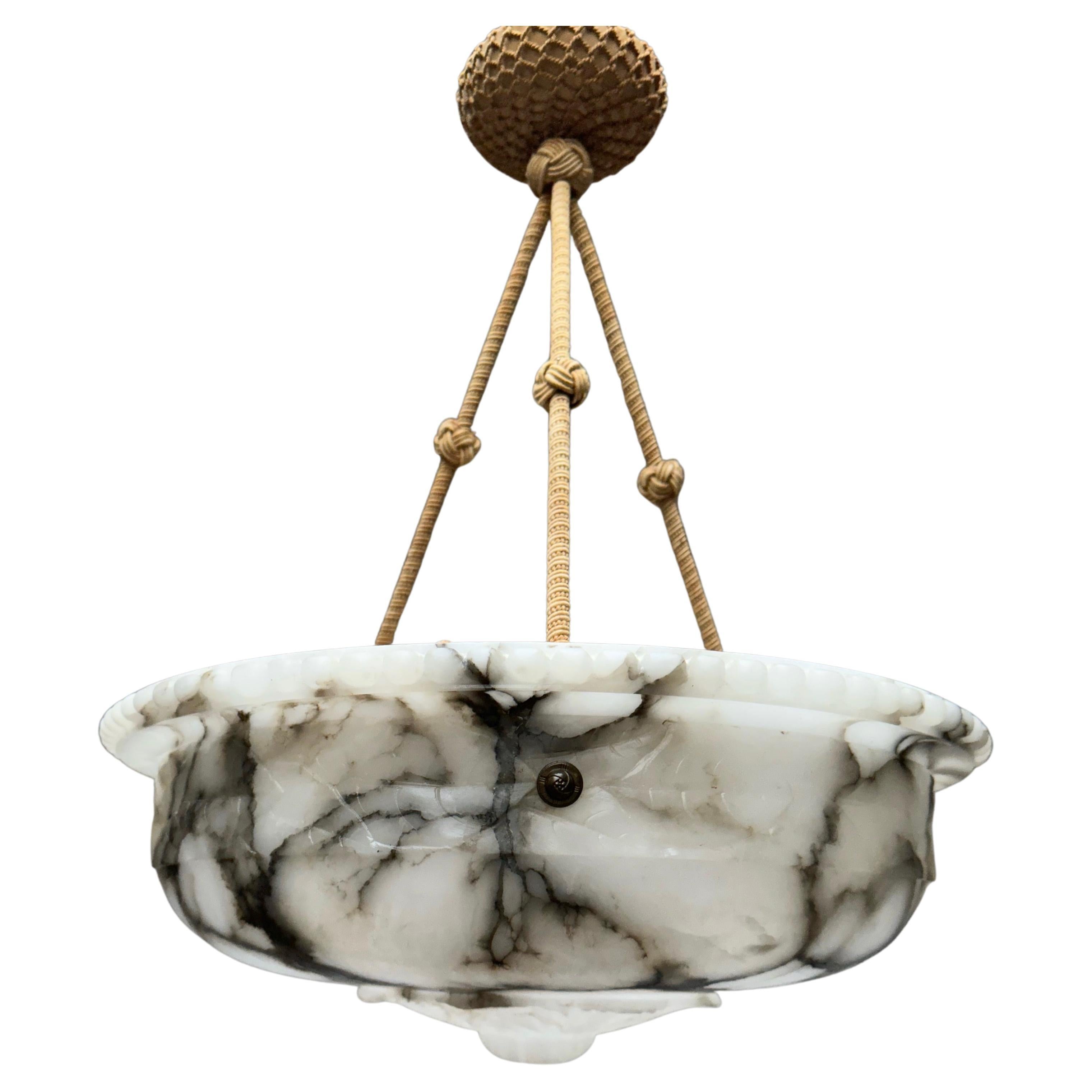Antique 3-light chandelier with a large size and beautifully carved alabaster shade.

Thanks to its large size, its deep bowl shape and its classical design this great alabaster chandelier is bound to light up both your days and evenings. Besides