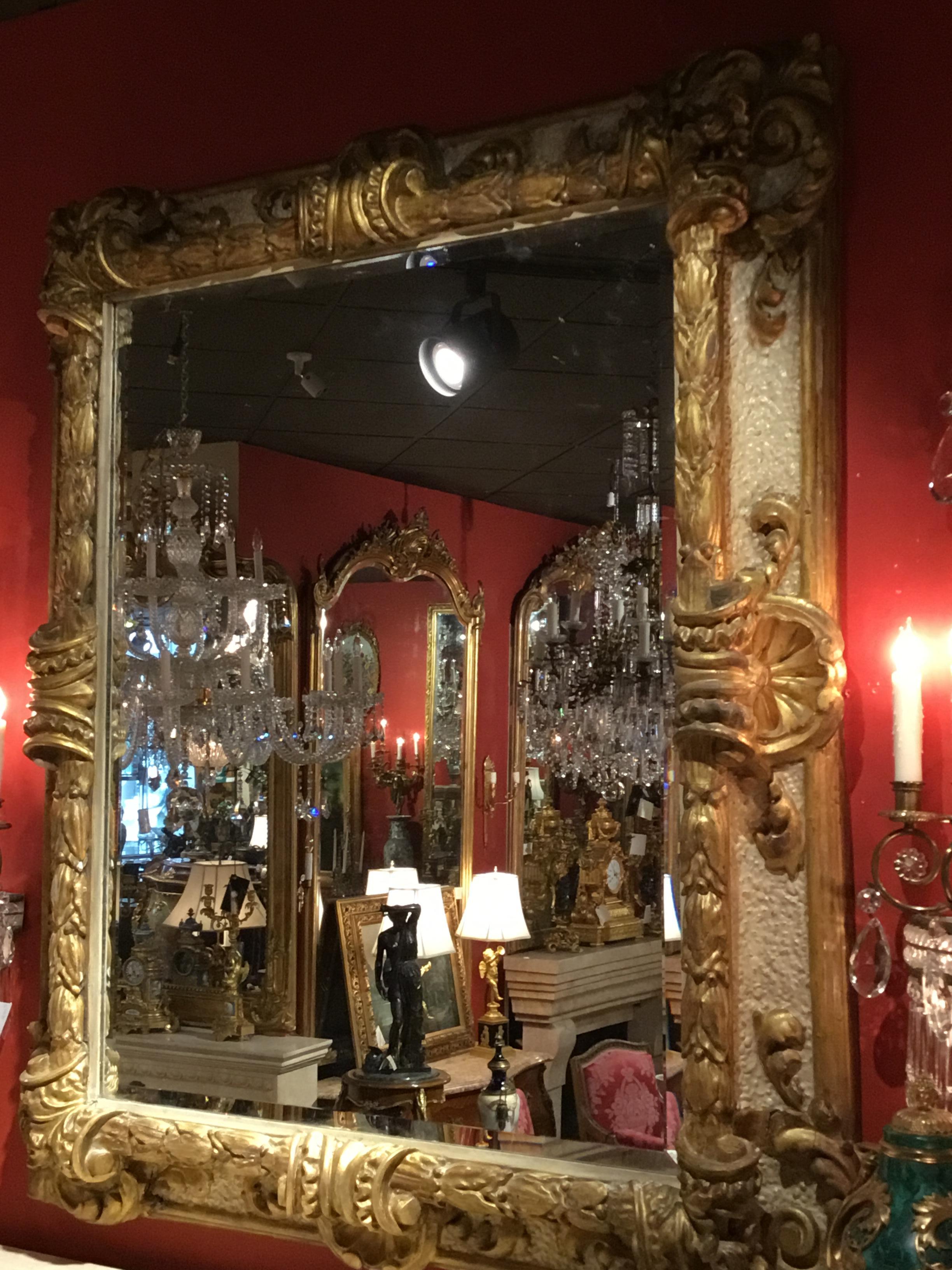 Parcel gilt and parcel paint embellish this beautifully carved frame surrounding 
This beveled mirror. Italian carved with berry and leaf design and large scallops 
At the corners and midway down each side.
  