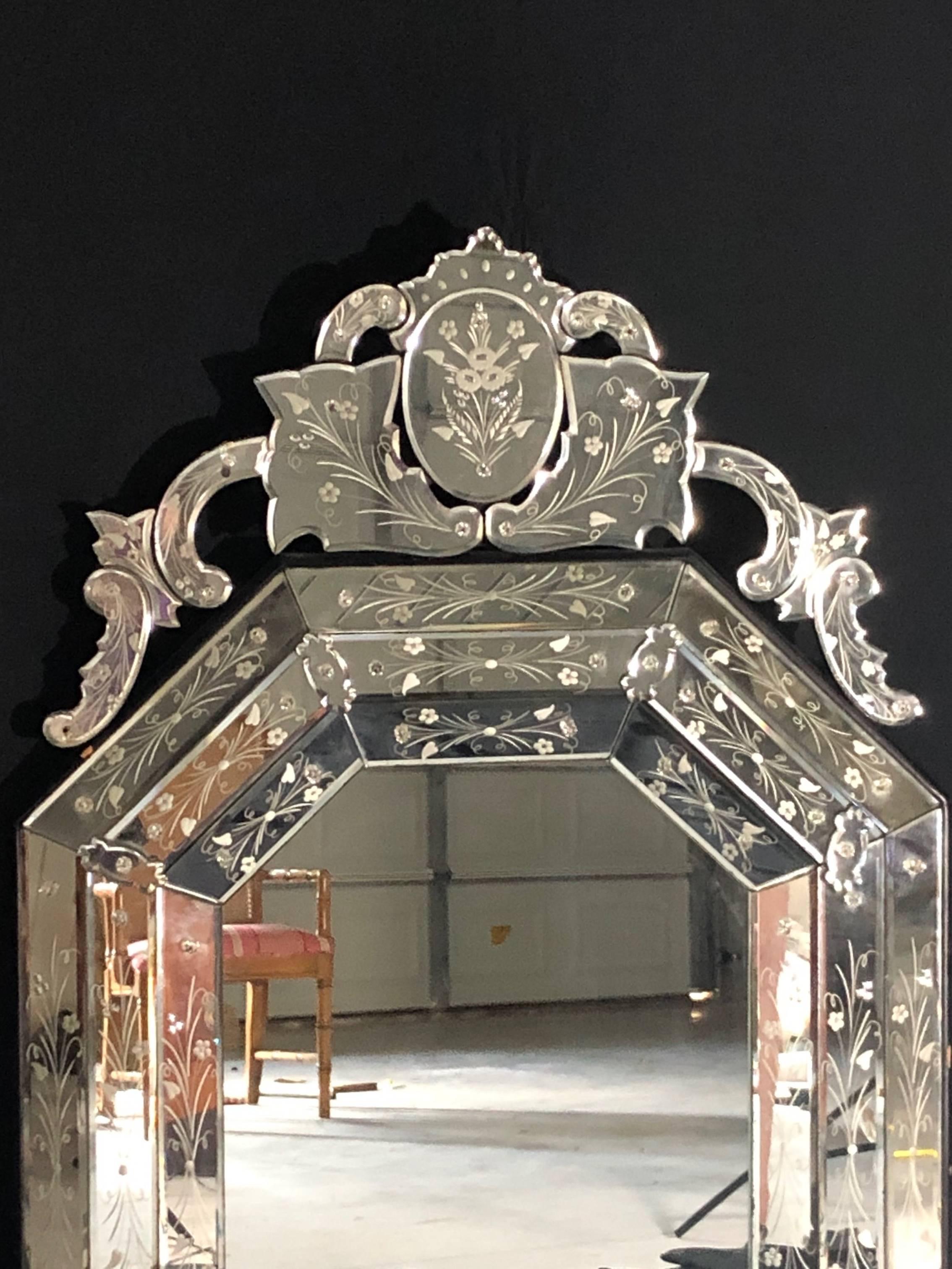 Lovely Venetian style mirror having octagonal shape with carved floral portrait in top oval. Significant size and detail! #5066.