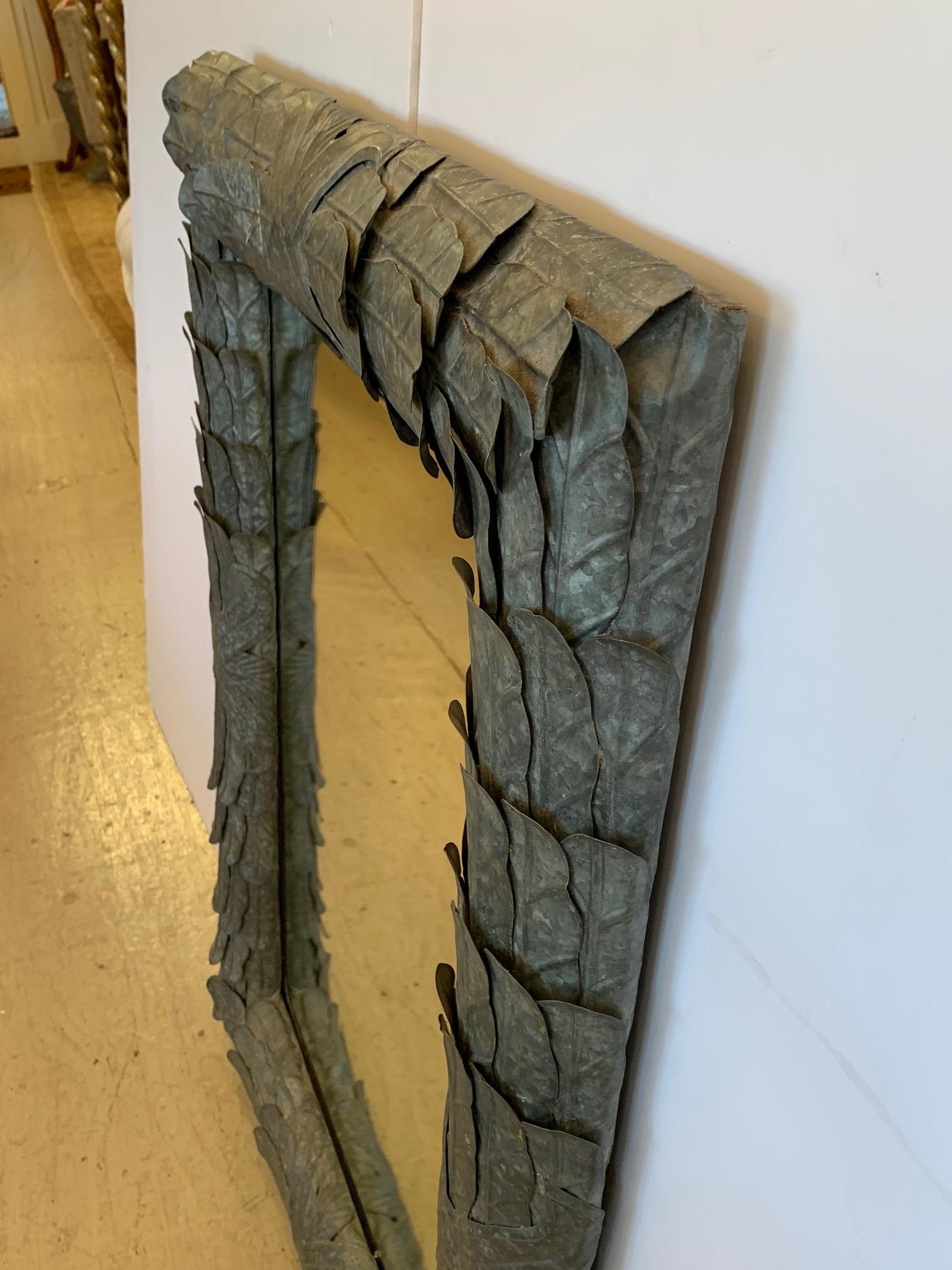 A very striking handmade zinc palm leaf motife mirror having bevelled mirror and wonderful patina.
Weighs approximately 60 lbs.
 