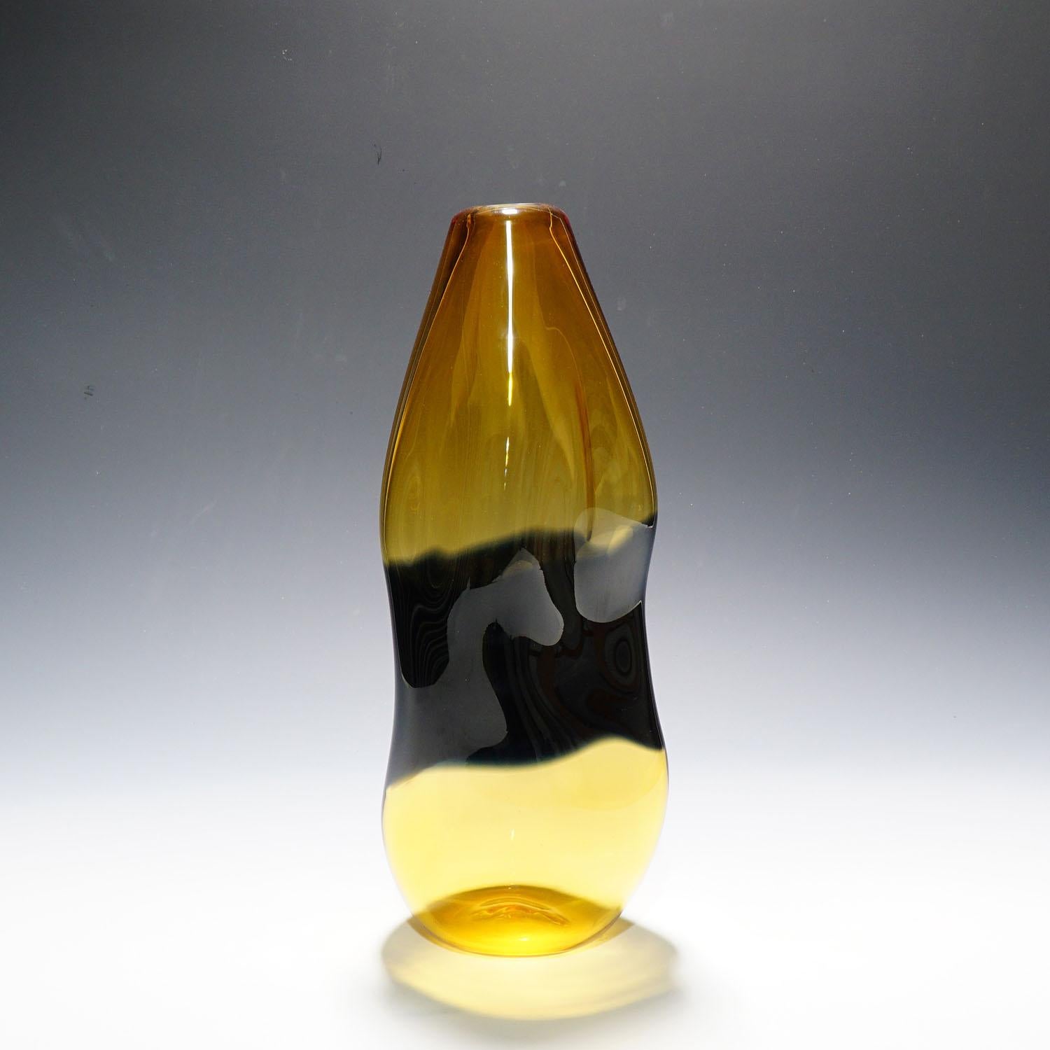 A large and decorative murano glass vase of the 'Fiapi' series designed by Carlo Nason and manufactured by V. Nason & C. Murano end of the 20th century. Amber and black glass fused in incalmo technicue and asymetrical shaped. Lable of the