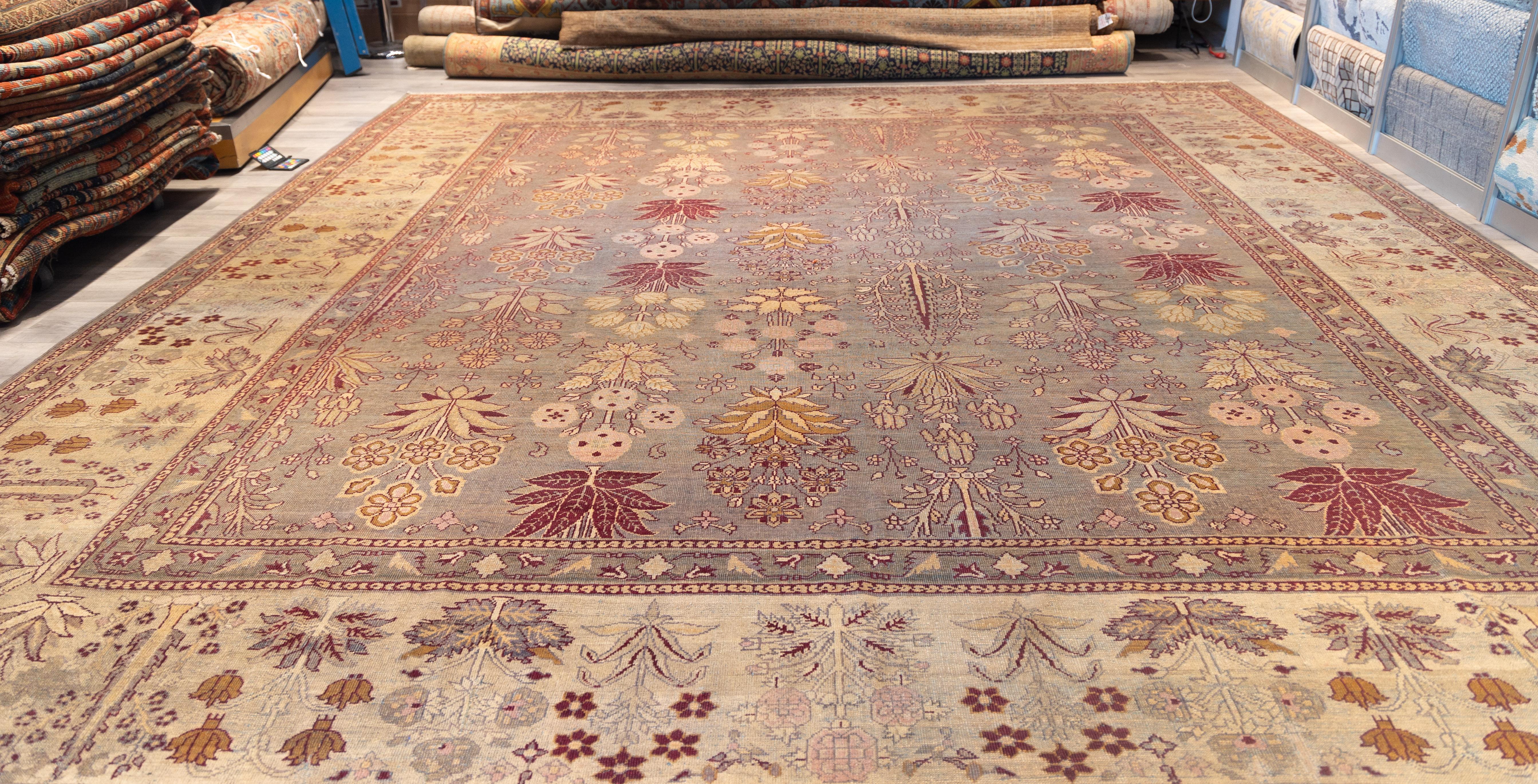 Indian Amritsar Rug from 19th century.  Allover floral pattern with stylized bouquets and palmettes in soft crimson, saffron, ivory, and lavender against a muted taupe ground. The border is densely filled with delicate botanical motifs and flowering