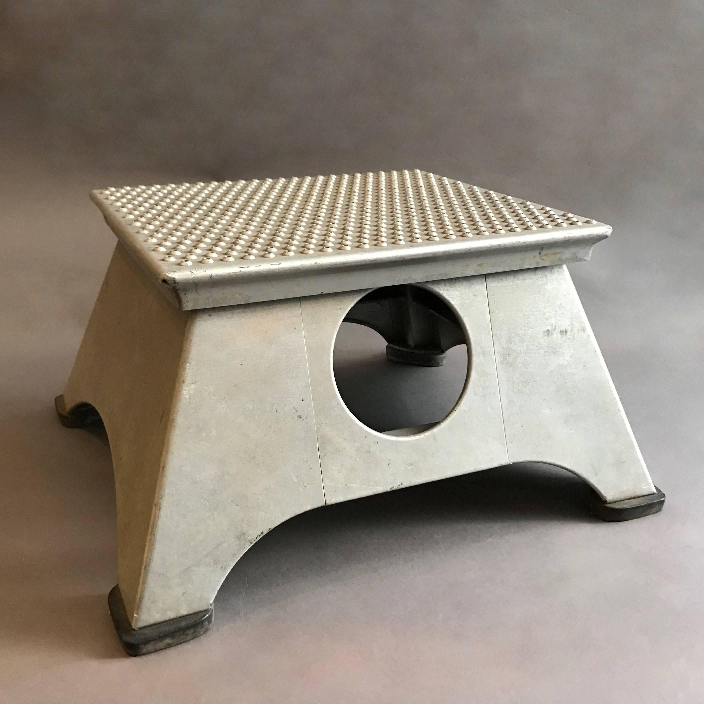 Industrial, mid-20th century, aluminum, train conductor, step stool features open handles on two sides and a perforated slip grip top. Measure: The top tapers to 13 inches x 16 inches.