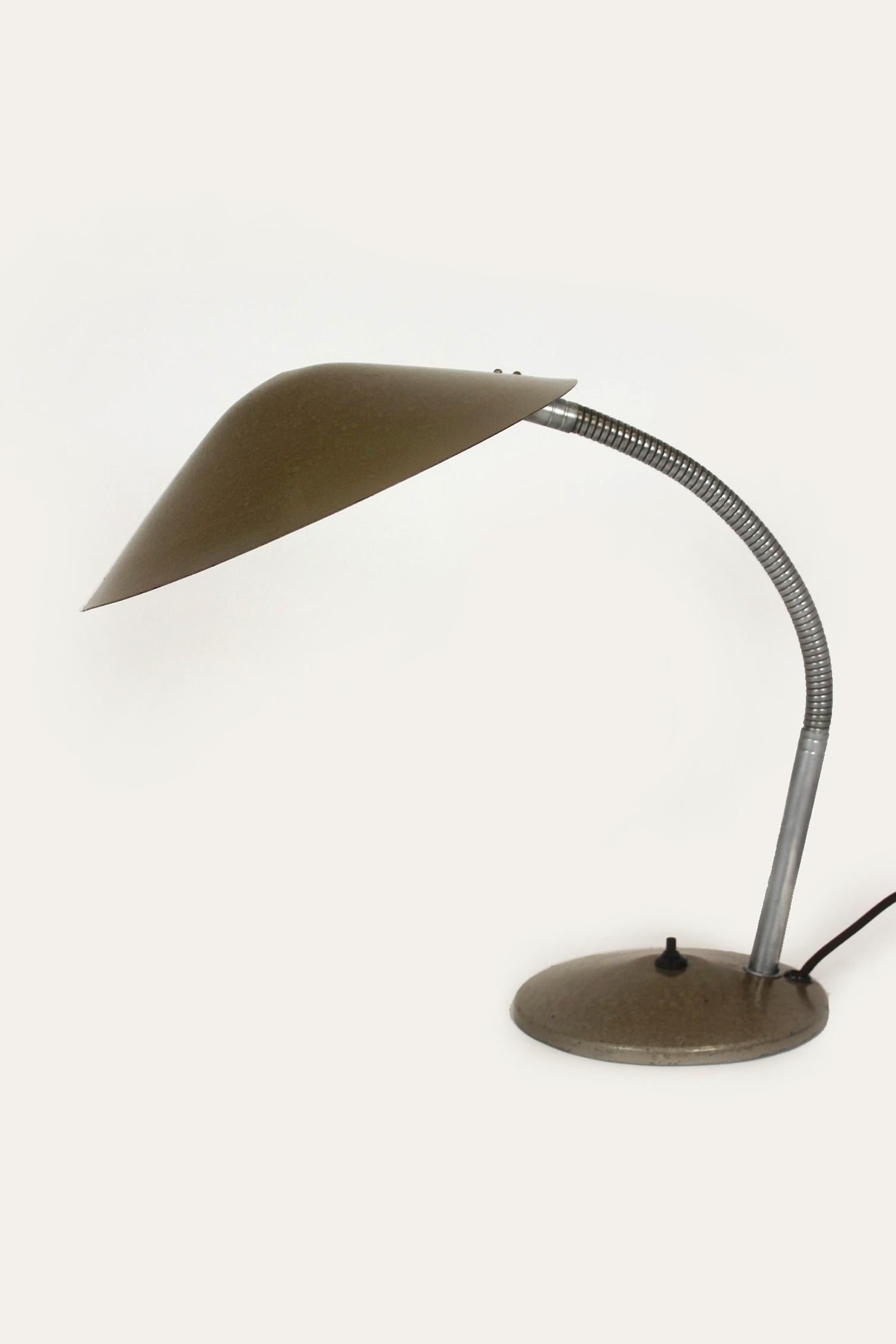 This large industrial steel lamp in the Bauhaus style was produced in the Czech Republic in the 1940s. It is in very good condition and fully functional, the lamp arm is adjustable.