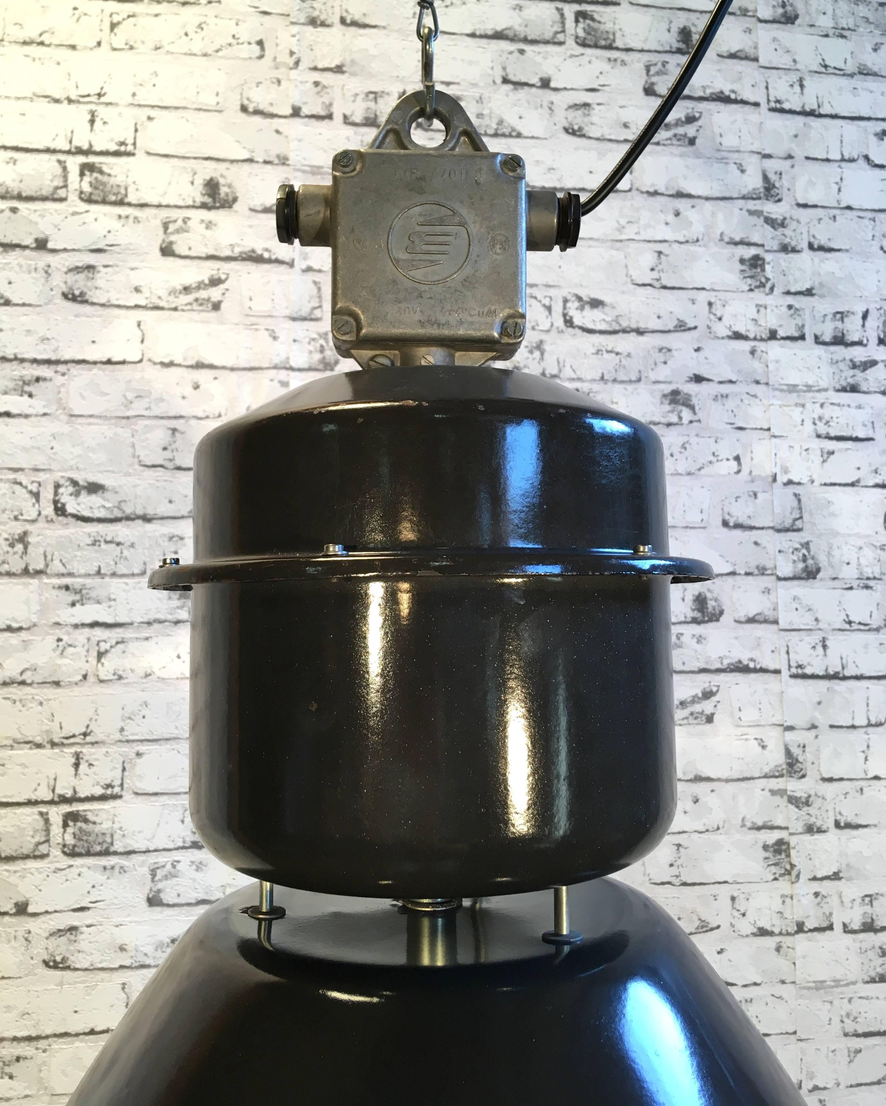 This steel black enamel pendant lamp was designed in the 1960s and produced by Elektrosvit in the former Czechoslovakia. It features a cast aluminium top, black enamel exterior, white interior and clear glass cover.
Lamp is in very good vintage