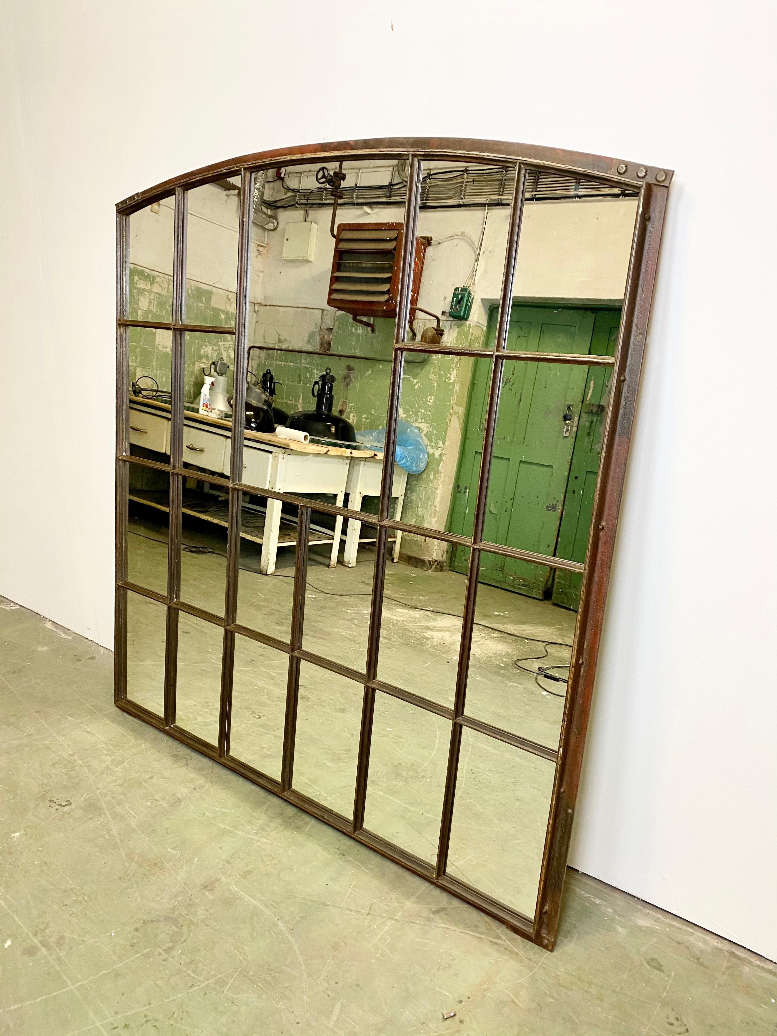 Large cast iron arched Industrial window frame has been transformed into a mirror. The weight of the mirror is 85 kg.