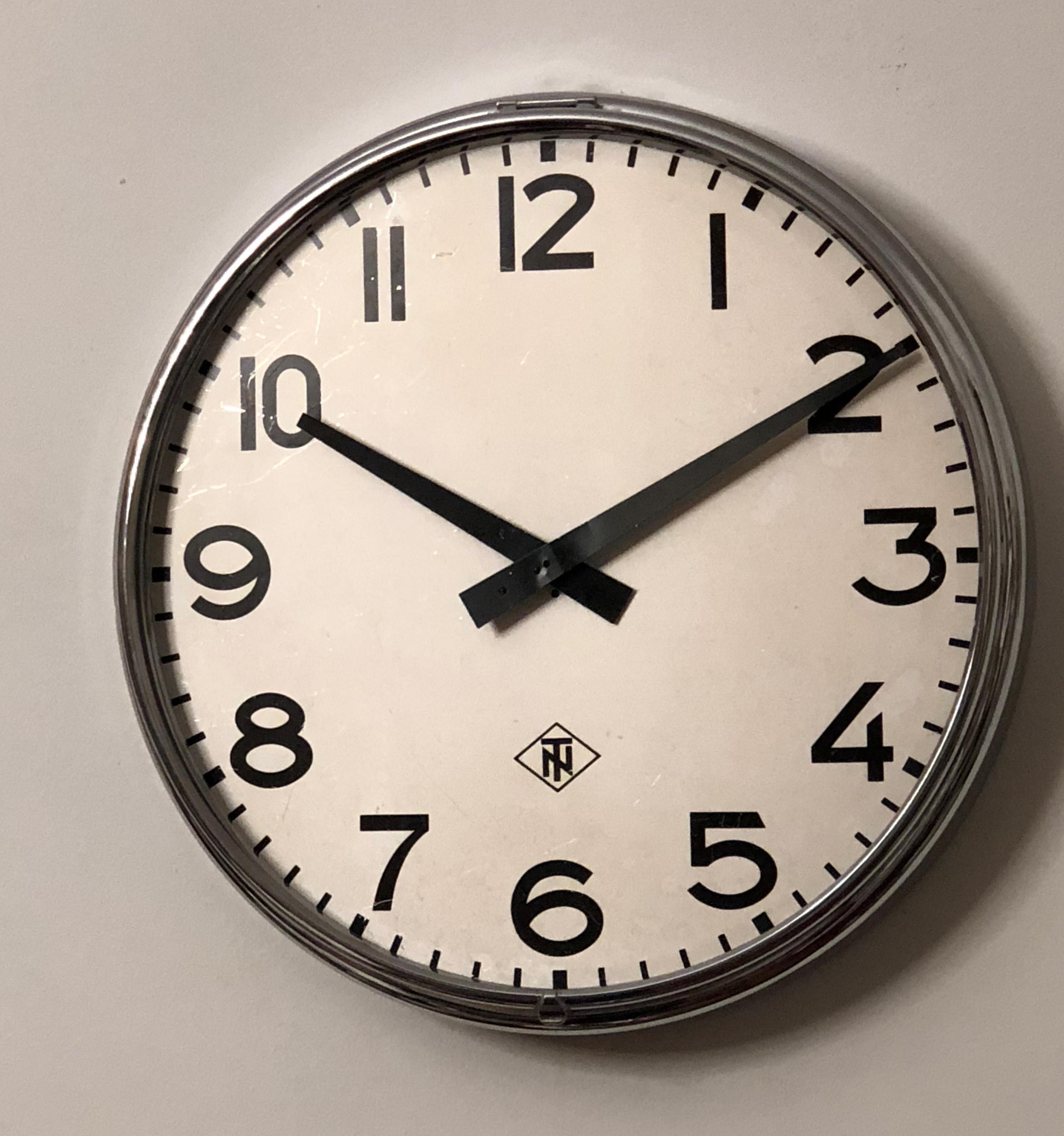 Steel frame painted with an aluminum clock face, clock hand and glass cover. Made in Germany in the late 1970s by TN (Telefonbau und Normalzeit). Formerly a slave clock, it is now fitted with a modern quartz movement with an AA battery. Used but in