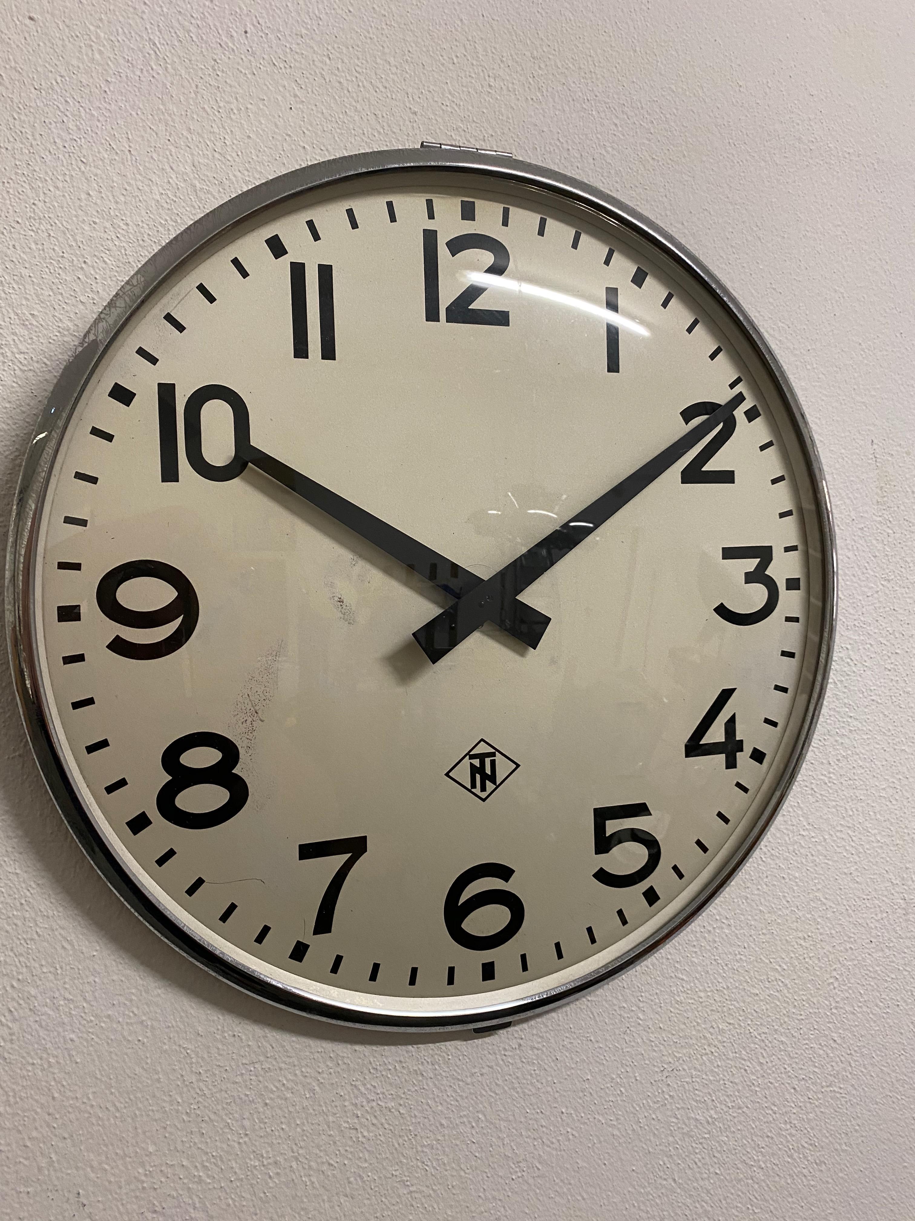 Steel frame painted with an aluminum clock face, clock hand and glass cover. Made in Germany in the late 1970s by TN (Telefonbau und Normalzeit). Formerly a slave clock, it is now fitted with a modern quartz movement with an AA battery. Used but in