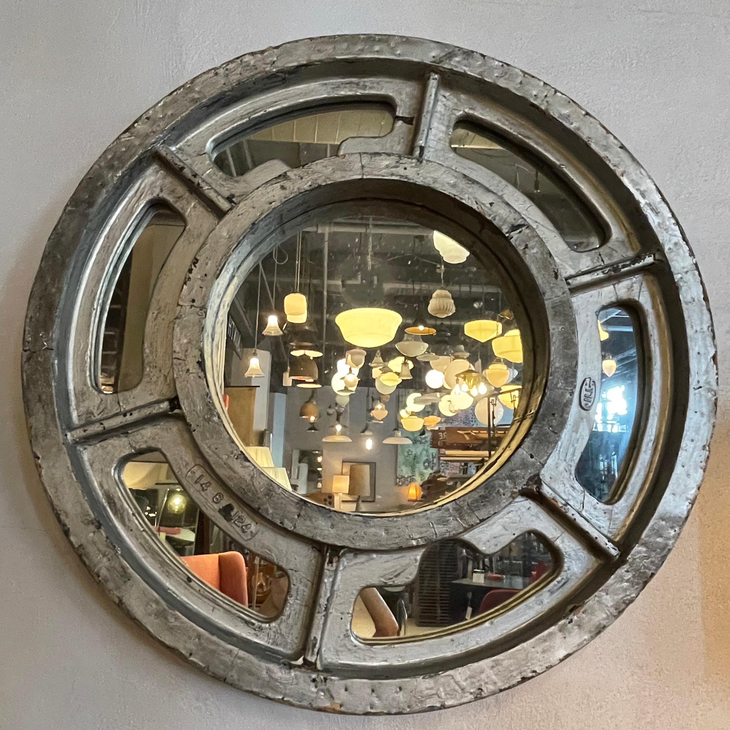Large, round, Industrial, gear pattern mirror features a silver painted mahogany, foundry mold frame with perfect, original patina.
