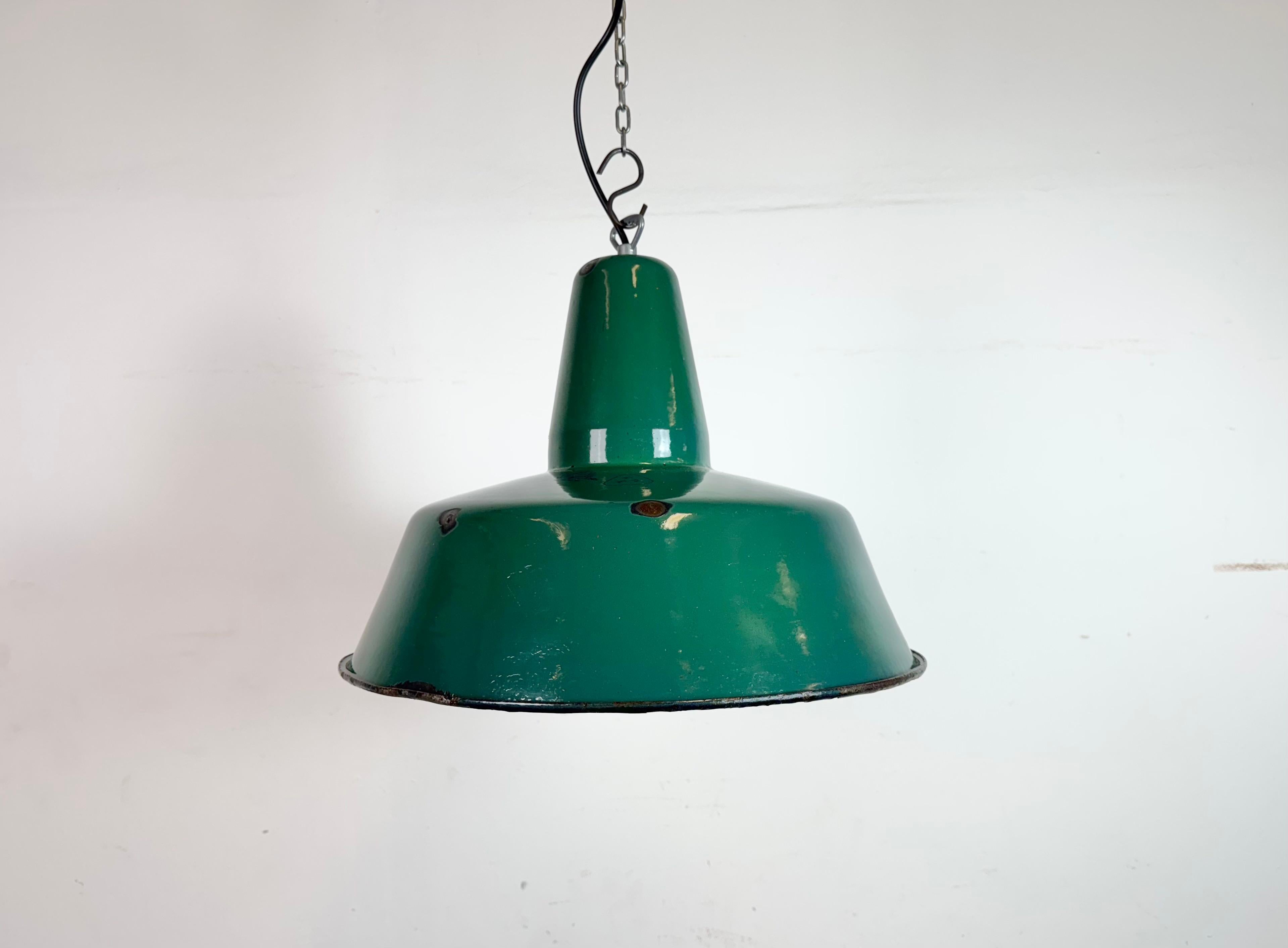 Industrial green enamel pendant light made in Poland during the 1960s. White enamel inside the shade. Iron top. The socket requires standard E27/ E26 light bulbs. New wire. The weight of the lamp is 2 kg. The diameter of the lampshade is 41 cm.