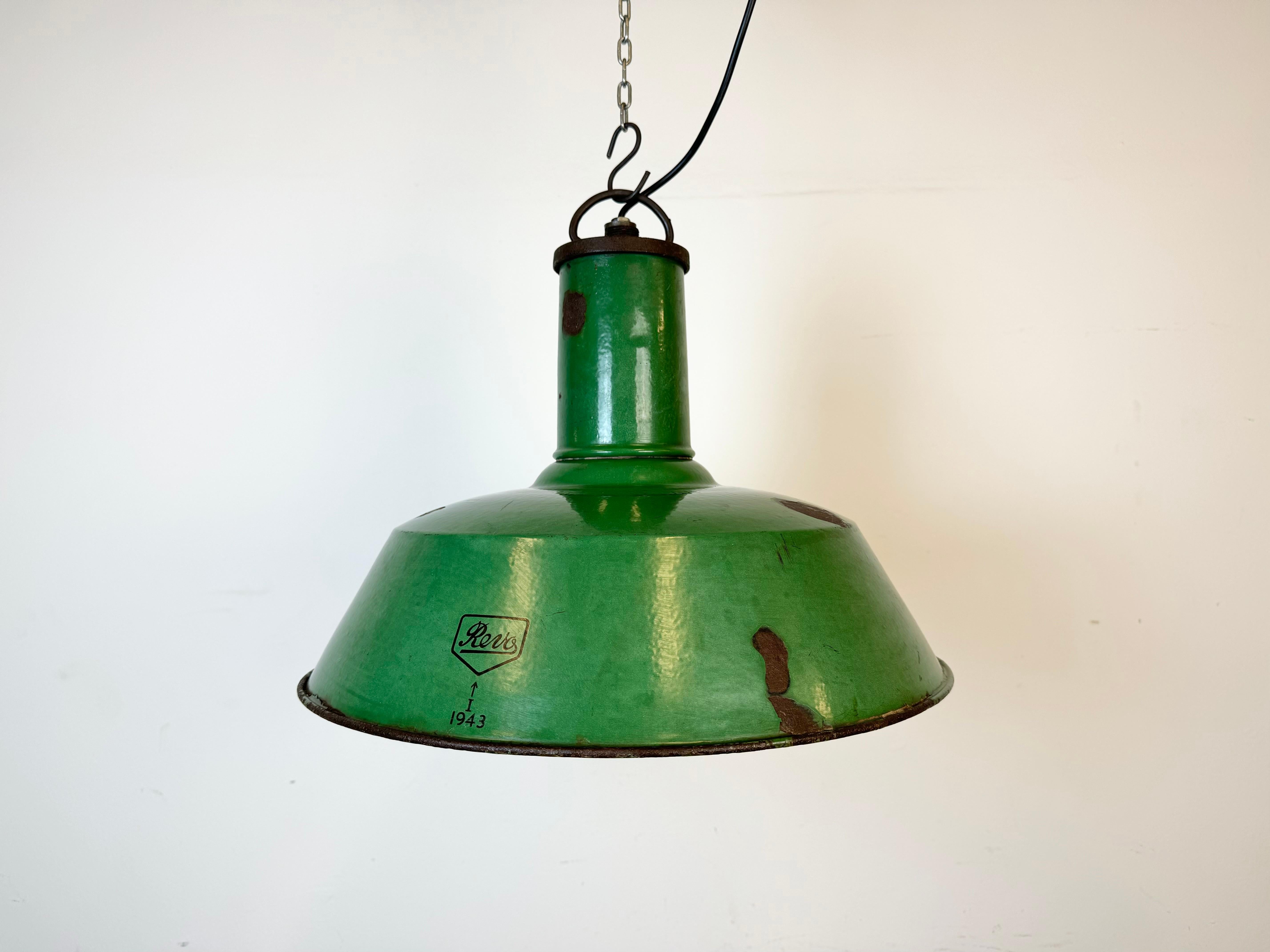 Industrial green enamel pendant light made by Revo in United Kingdom during the 1940s. White enamel inside the shade. Iron top. The socket requires standard E 27/ E 26 light bulbs. New wire. The weight of the lamp is 2.3 kg.The diameter of the lamp