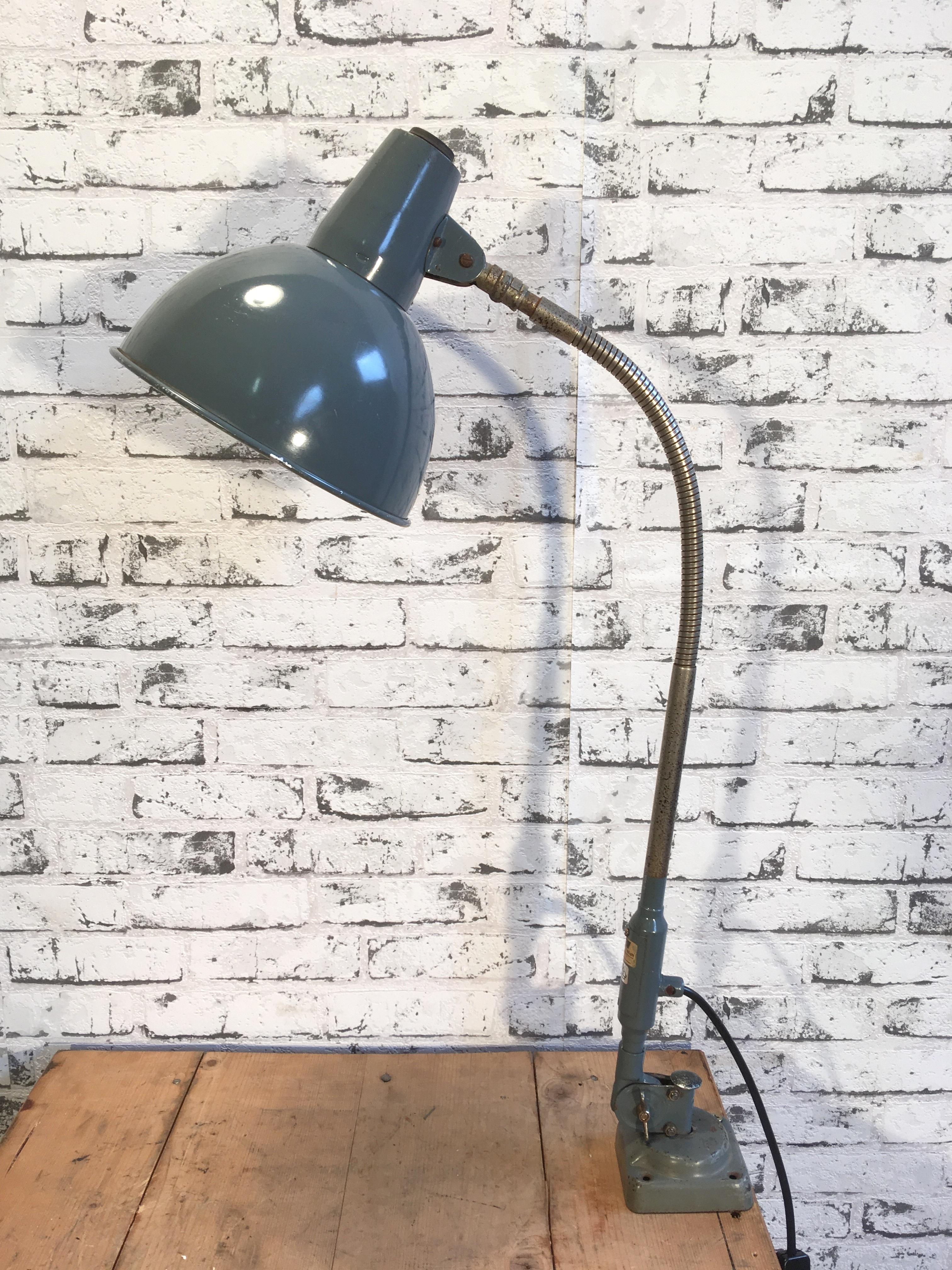 This Industrial adjustable table lamp was made by SIS (Sirius Schweinfurt, Gebr. Lang & Co. Germany) in Germany during the 1950s.It features grey aluminium shade, iron base and chrome-plated gooseneck. Socket for E 27 bulbs, new wire. Good vintage