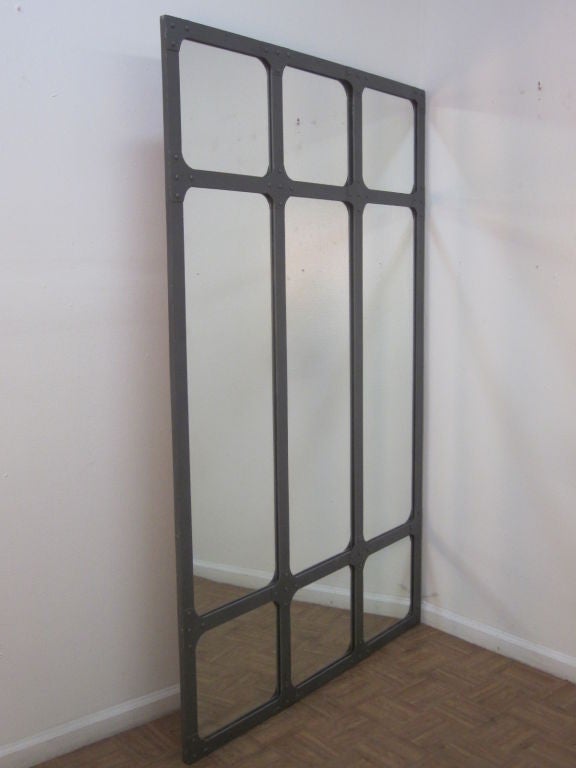 Large, heavy wrought iron mirror with a window pane design.