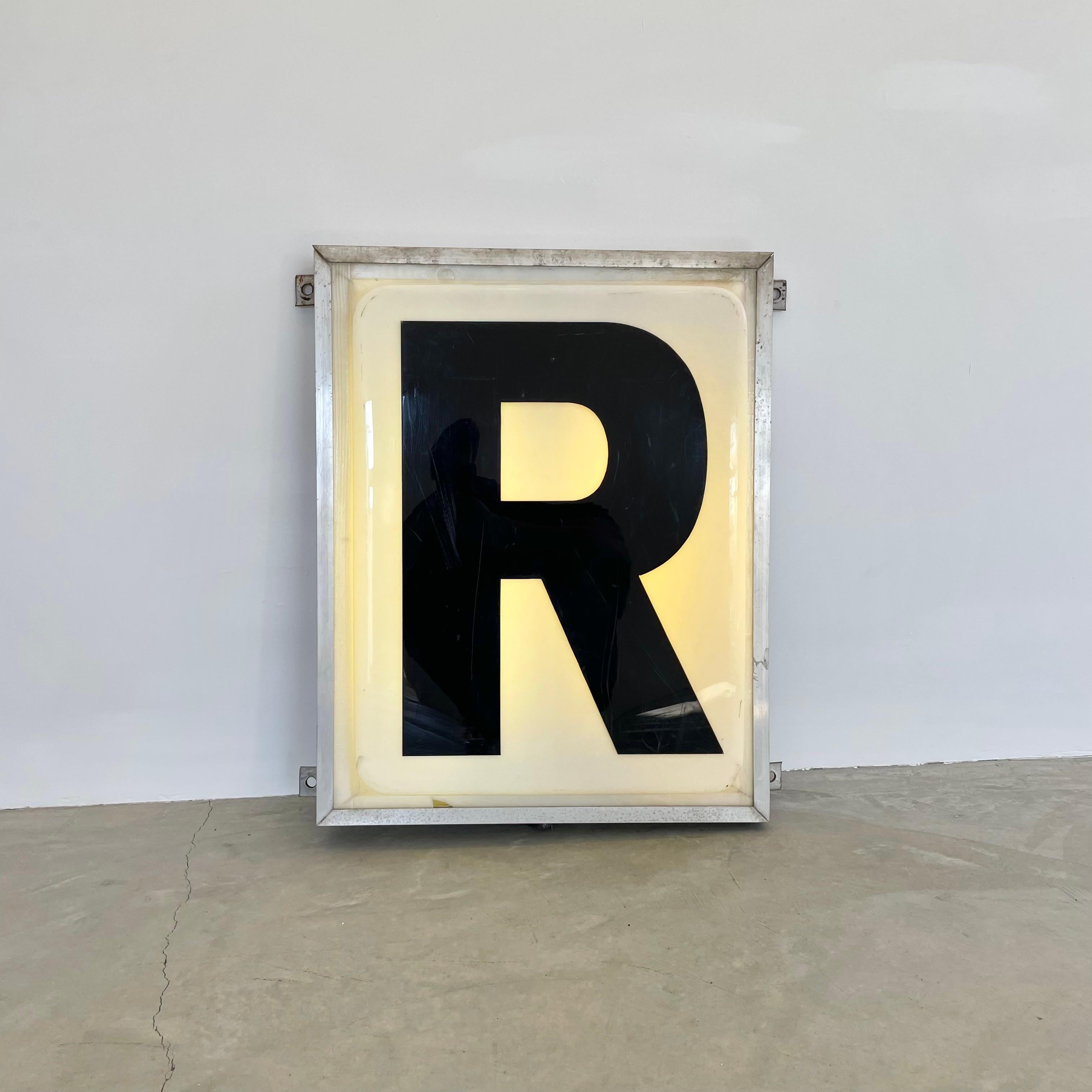 Large industrial illuminating electric letter ‘R’ sign from a Northwestern United States Emergency Room. 2 feet wide and 2.5 feet tall. Letter 'E' also available in a separate listing. Sticker on the bottom reads ‘Underwriters’ Laboratories, inc’ -