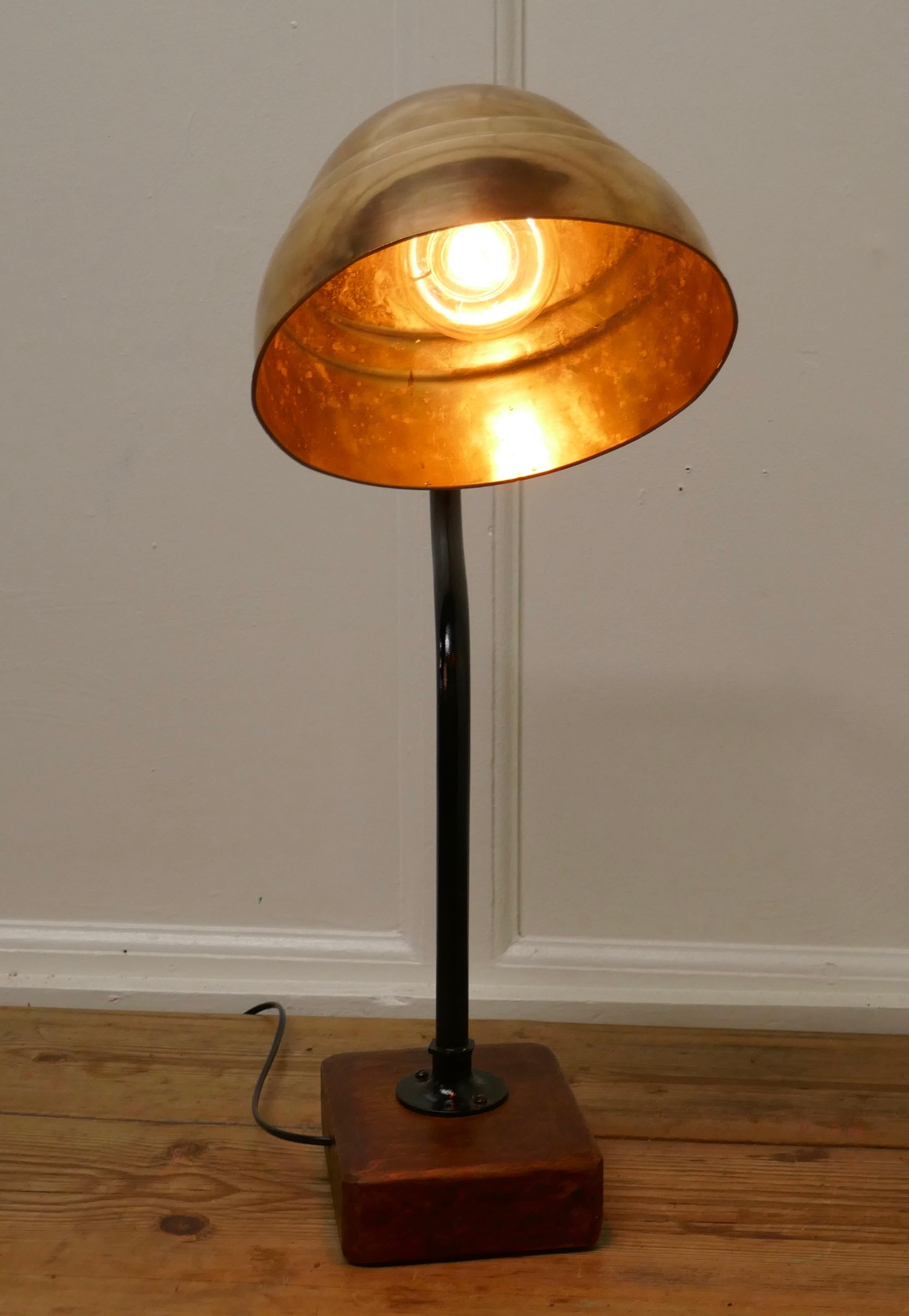 Large industrial look desk lamp

A great piece the large shade has been cleaned back to the brass which gives a great reflective quality, the Brass swan neck support is painted in black and set in a chinky oak base

The light is 25” tall, 18”